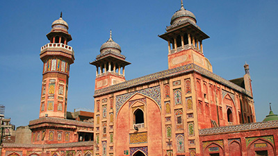 Photo of a mosque that was built by the Mughal Empire. The mosque is embellished with painted geometrical and floral designs.