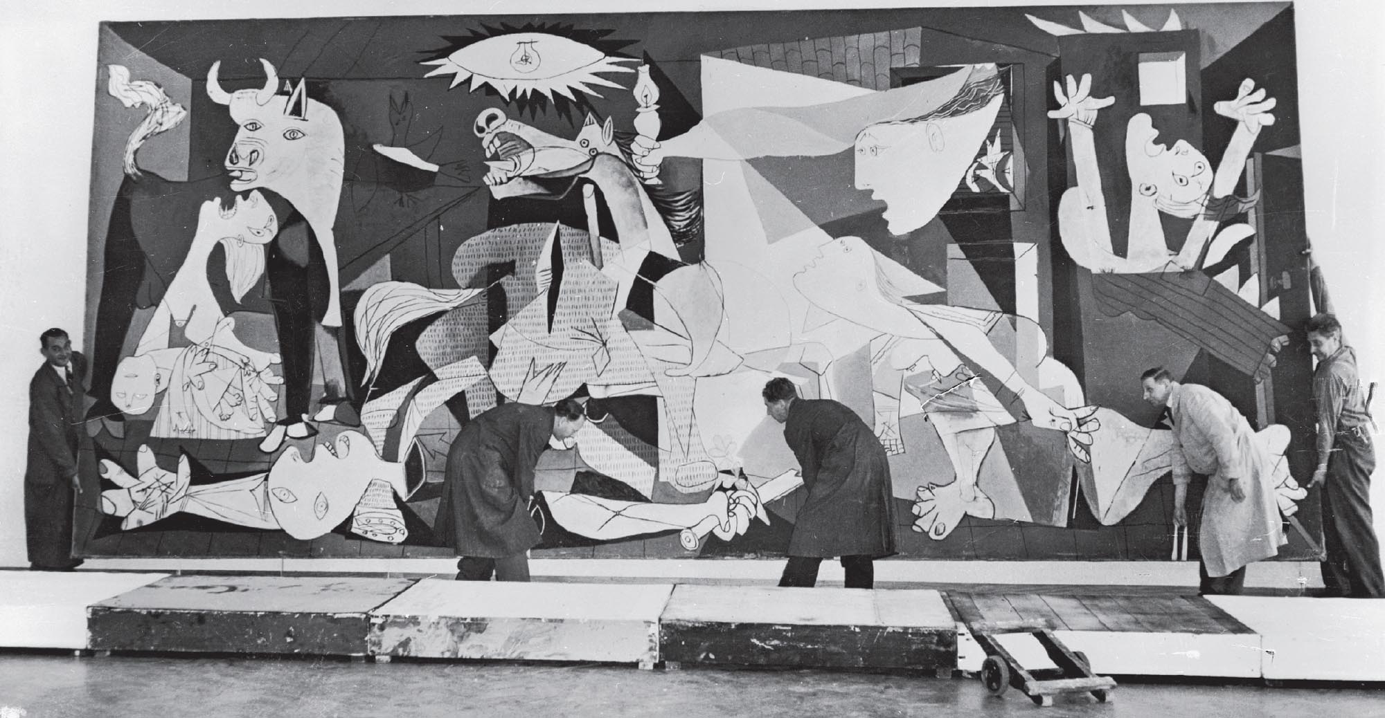 Museum workers installing Guernica, a large scale painting by Picasso, in the Municipal Museum in Amsterdam for an exhibition