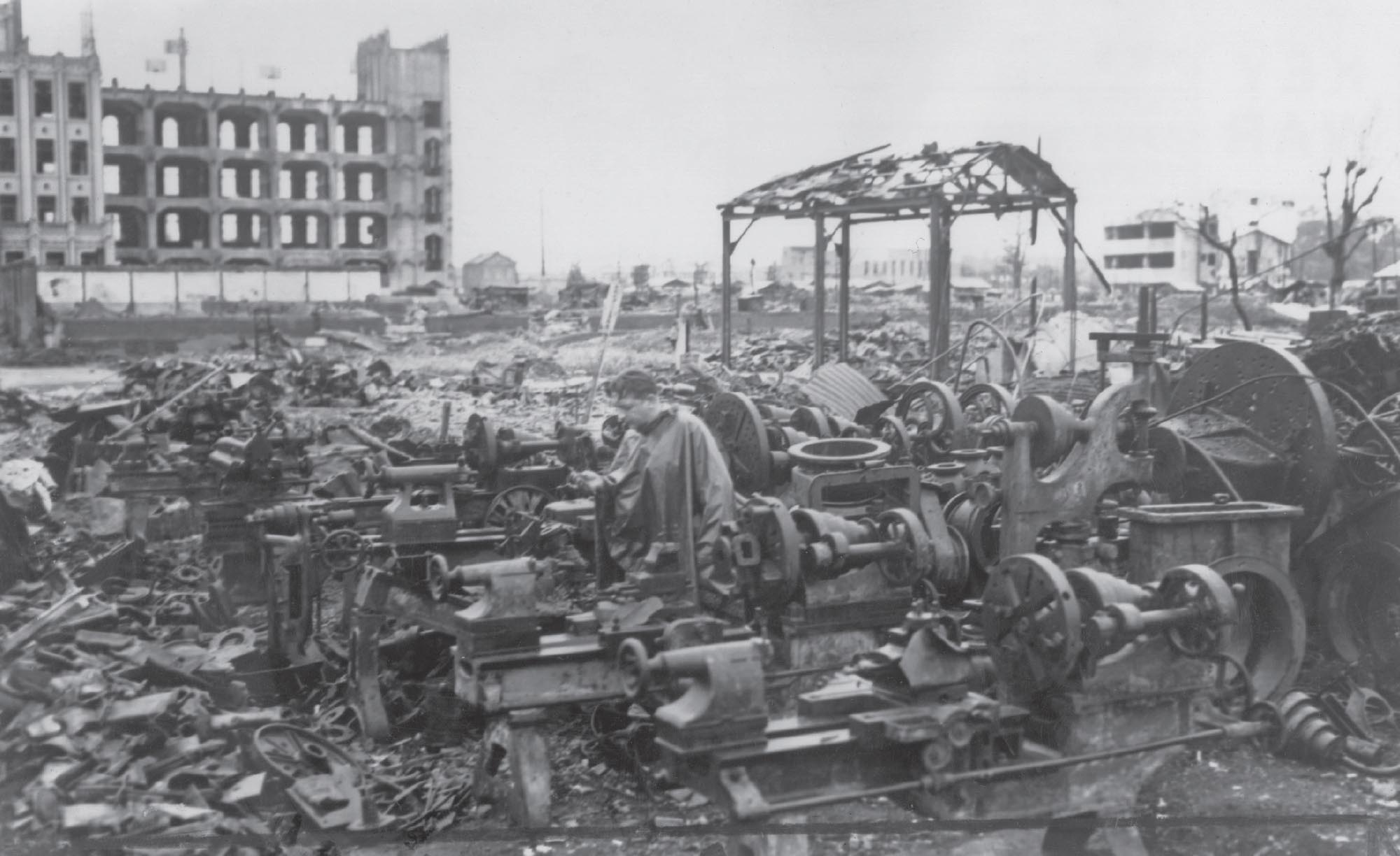 Broken machinery and burnt out buildings in Japan after bombings.