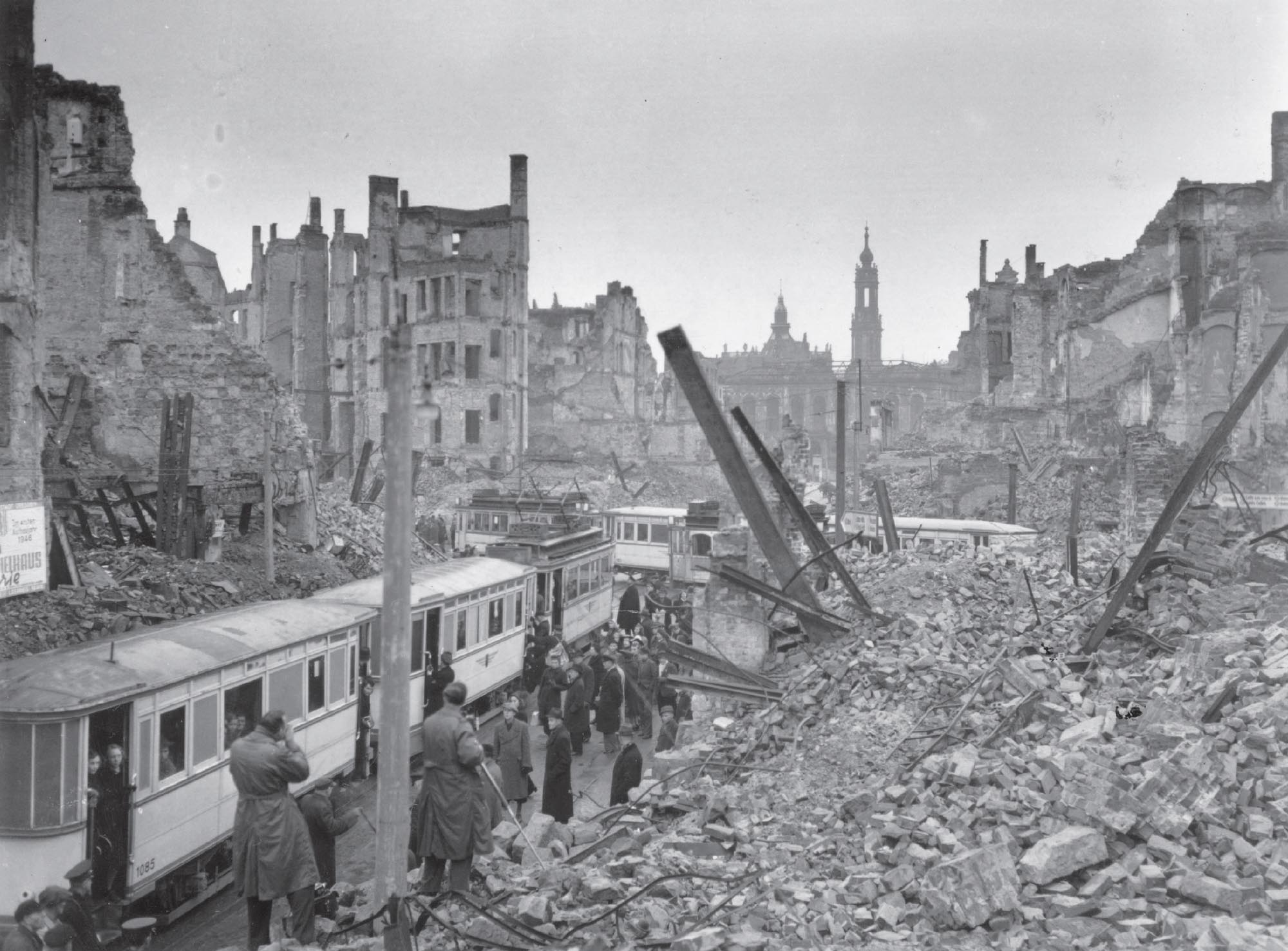 Remains of a city area in Germany after a bombing campaign with people getting on trains.