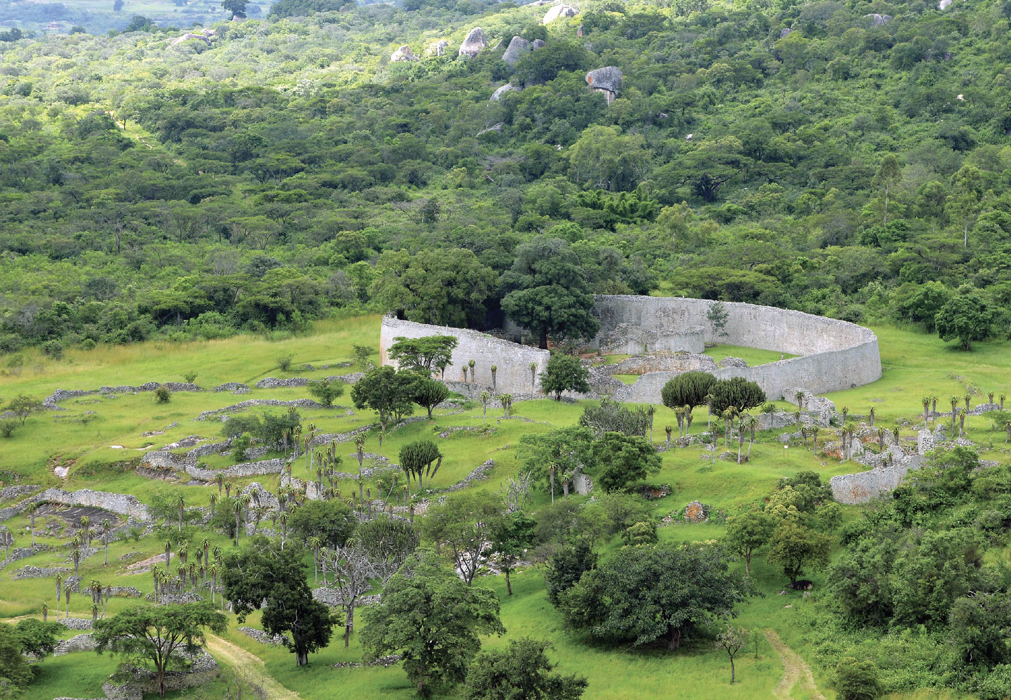 Walled enclosures with aloe trees and boulders.