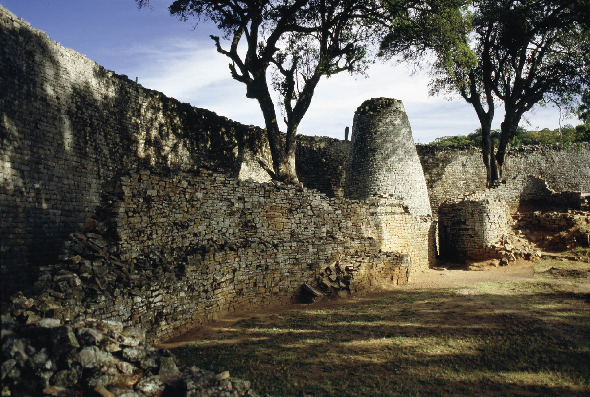 Photo of the remnants of a large, stone wall.