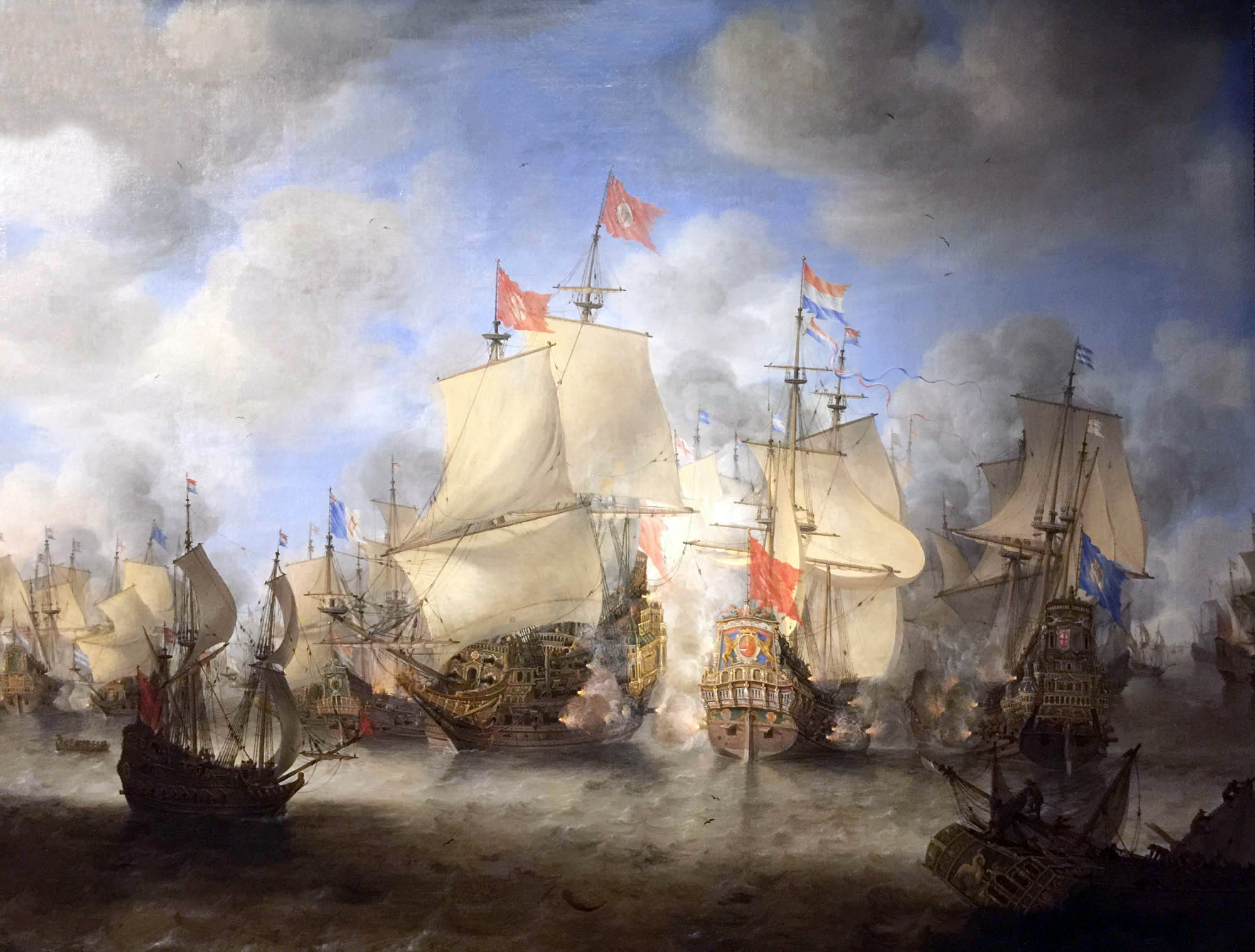 A painting of many ships in a harbor with flags of the Dutch East India flying.