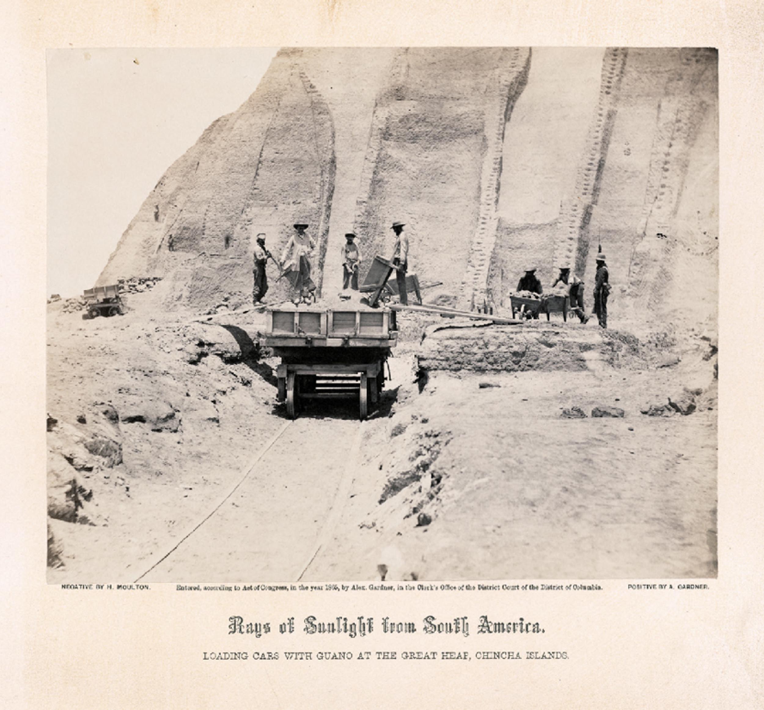 An image from the series, Guano mines in Peru: Workers loading mining carts with guan from the Great Heap.