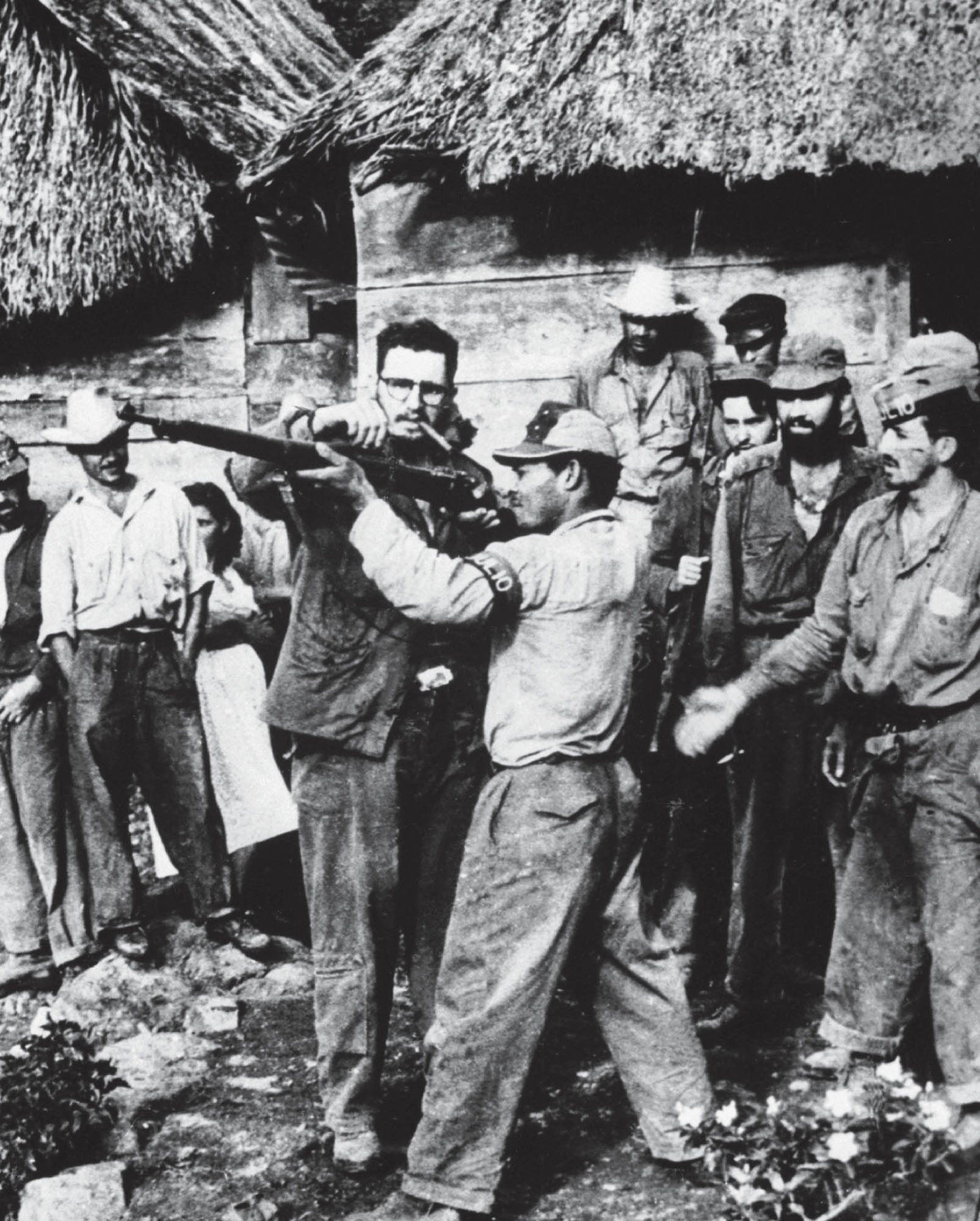 Guerilla fighters being given arms training by Fidel Castro.