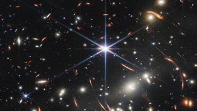 A small image slice of the deep field, distant universe showing thousands of galaxies. Produced by NASA’s James Webb Space Telescope.