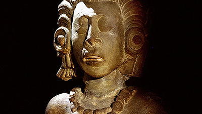 Sculpture of a maize god from the palace of Yax Pac. The god is a personified maize cob in the form of a beautiful young man, his hair the corn silk.