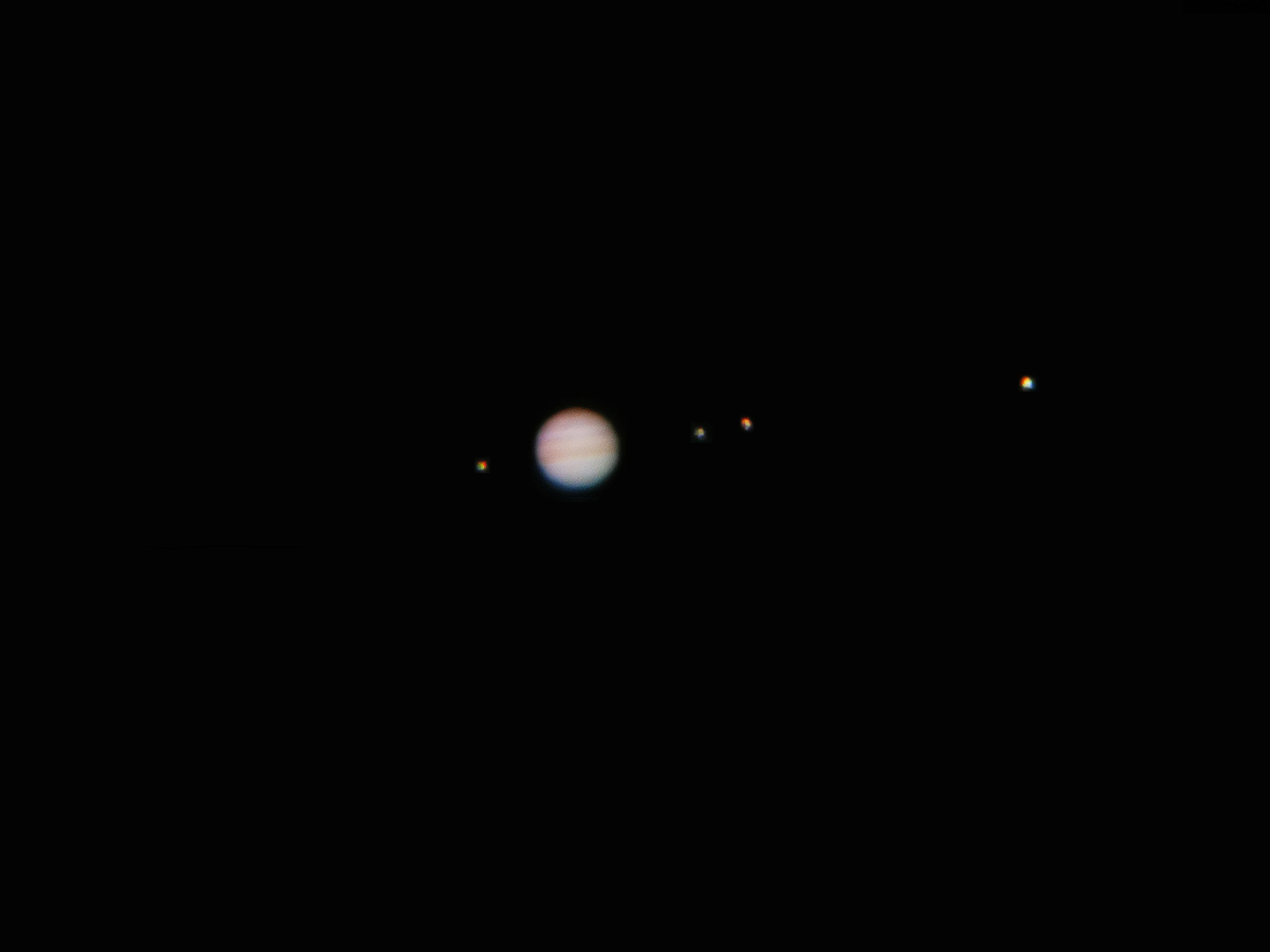 The planet of Jupiter with its four moons.