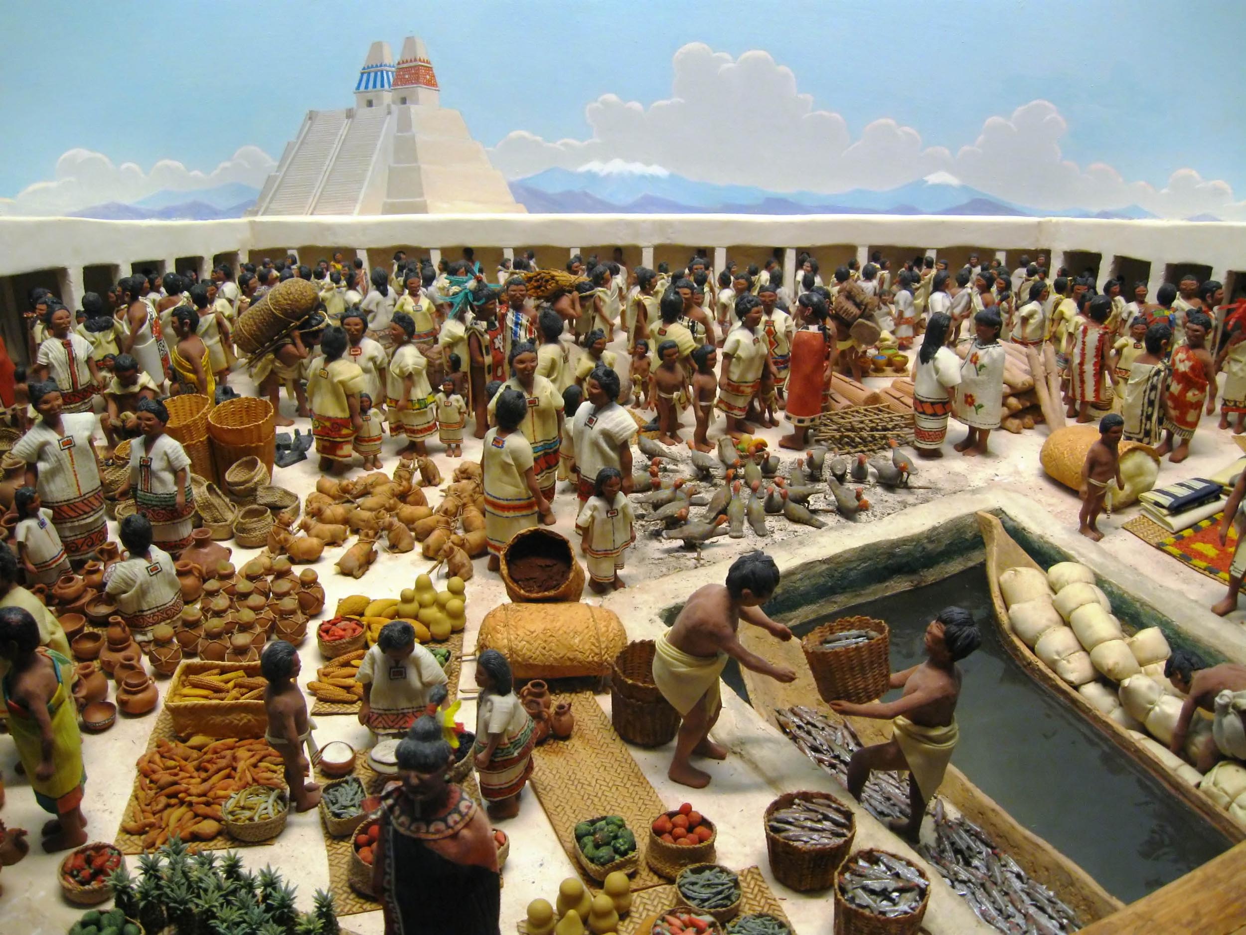 A model of a marketplace made out of clay. The marketplace is crowded with people trading goods like baskets, fish, vegetables, pottery, and textiles.