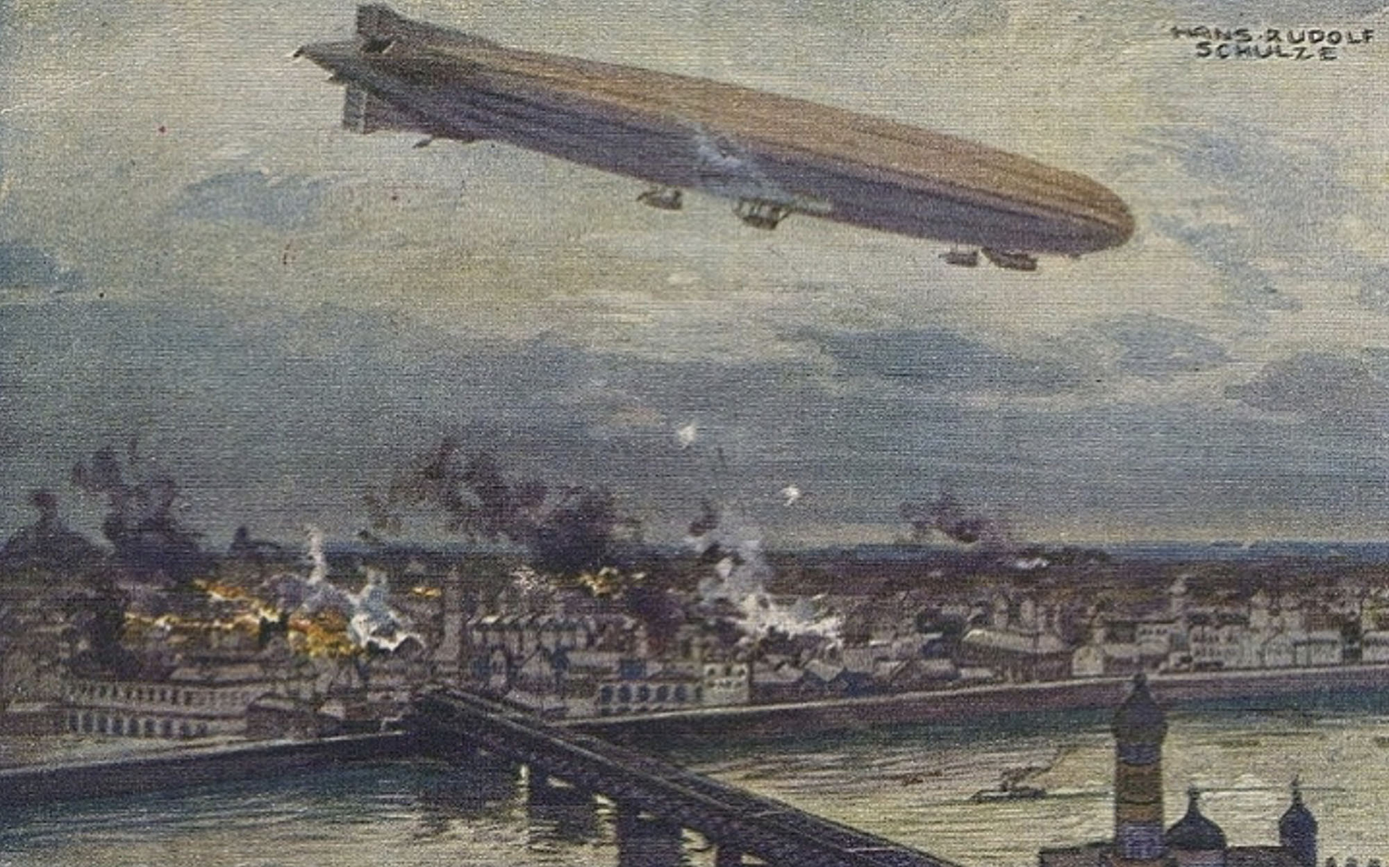 An illustration of a large zeppelin flying over a city at night, dropping bombs. Below, buildings burn with flames and smoke rising, and a bridge spans a river in the foreground.