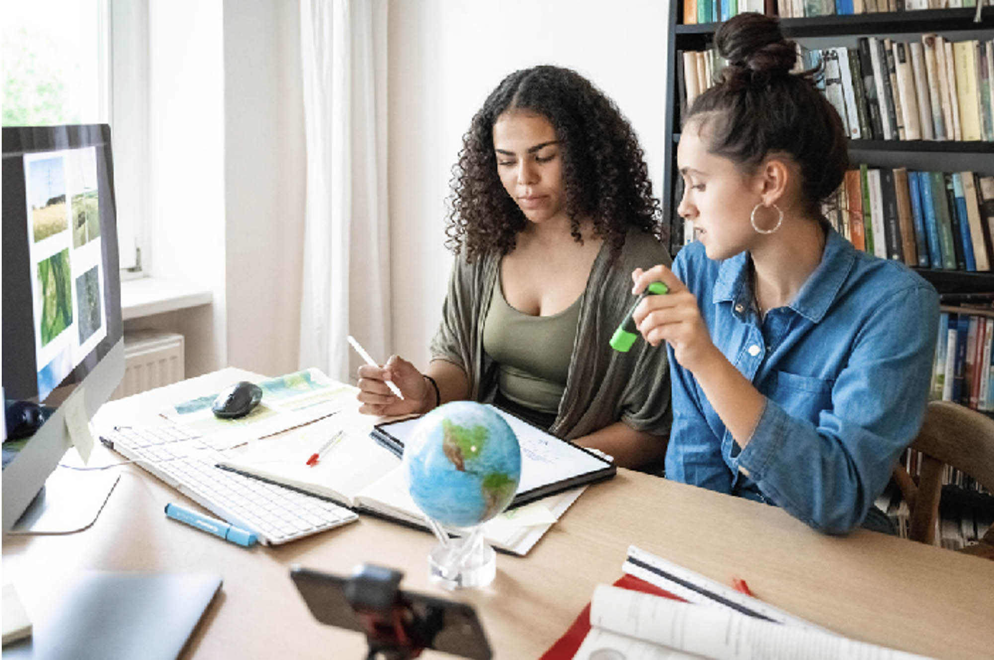 Two students working on an iPad preparing a presentation.