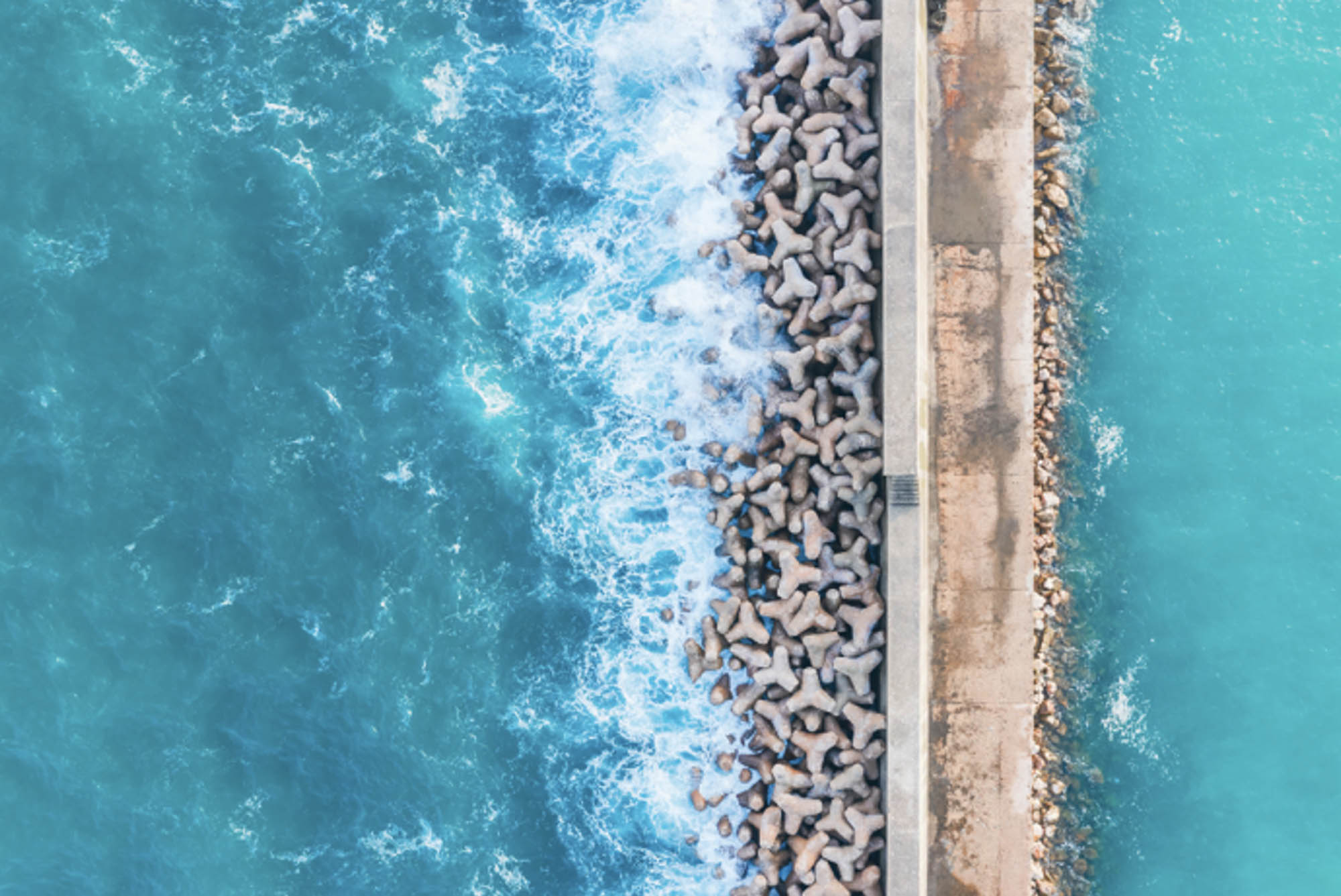 Aerial view of tetrapods as coastal harbour protection in Algarve, Portugal.