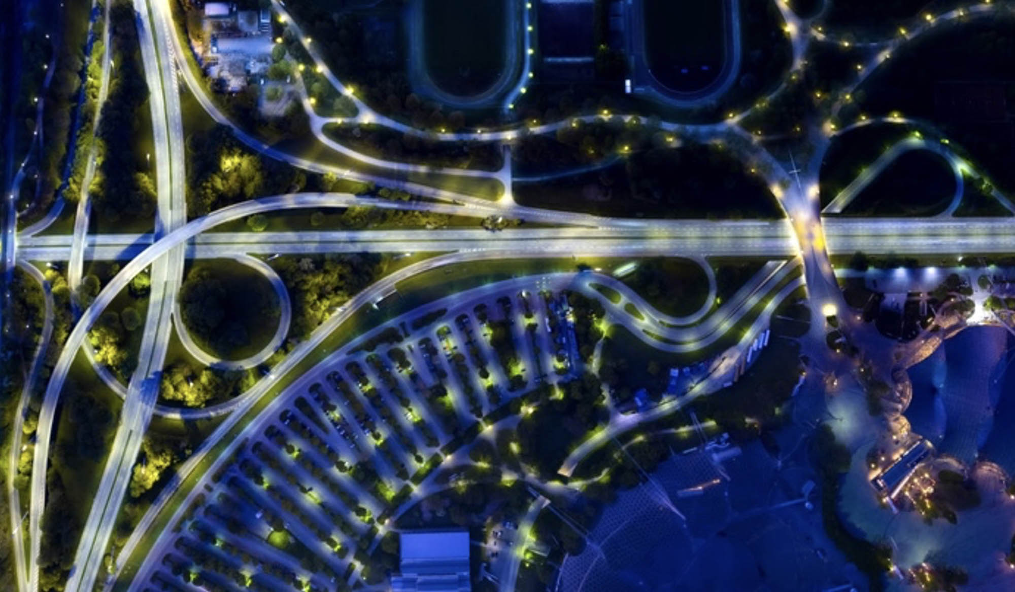 Aerial view of city’s lit up highway and infrastructure.