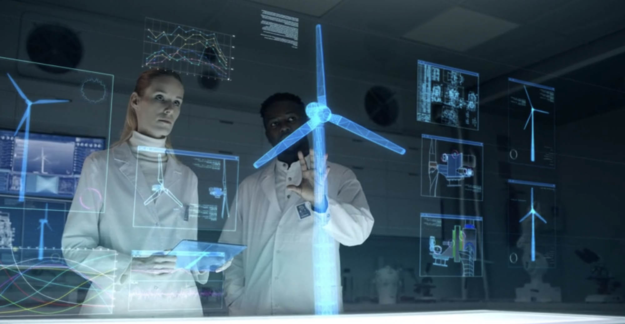 Two scientists examining and discussing the blueprint of a windmill.