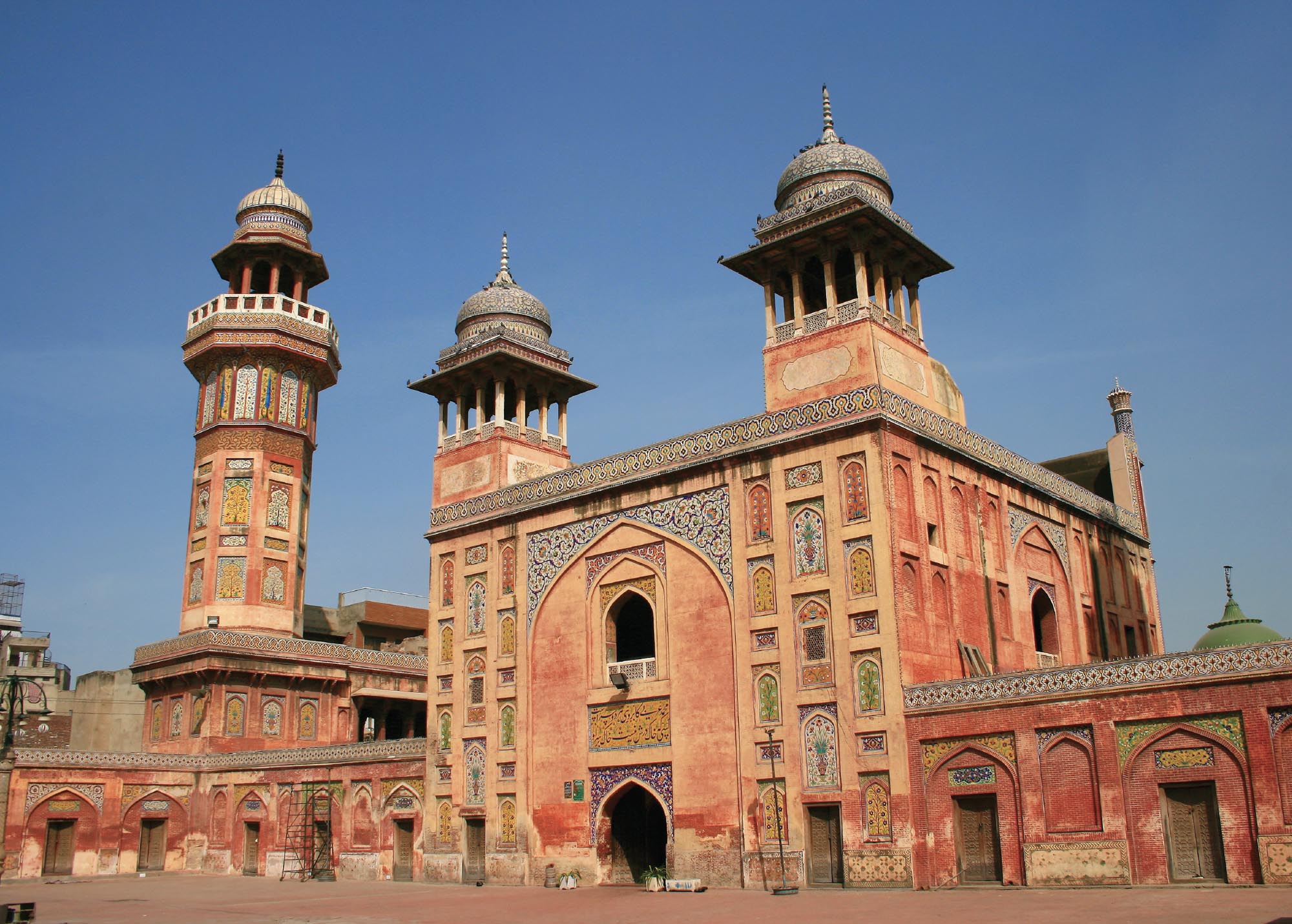 Photo of a mosque that was built by the Mughal Empire. The mosque is embellished with painted geometrical and floral designs.  