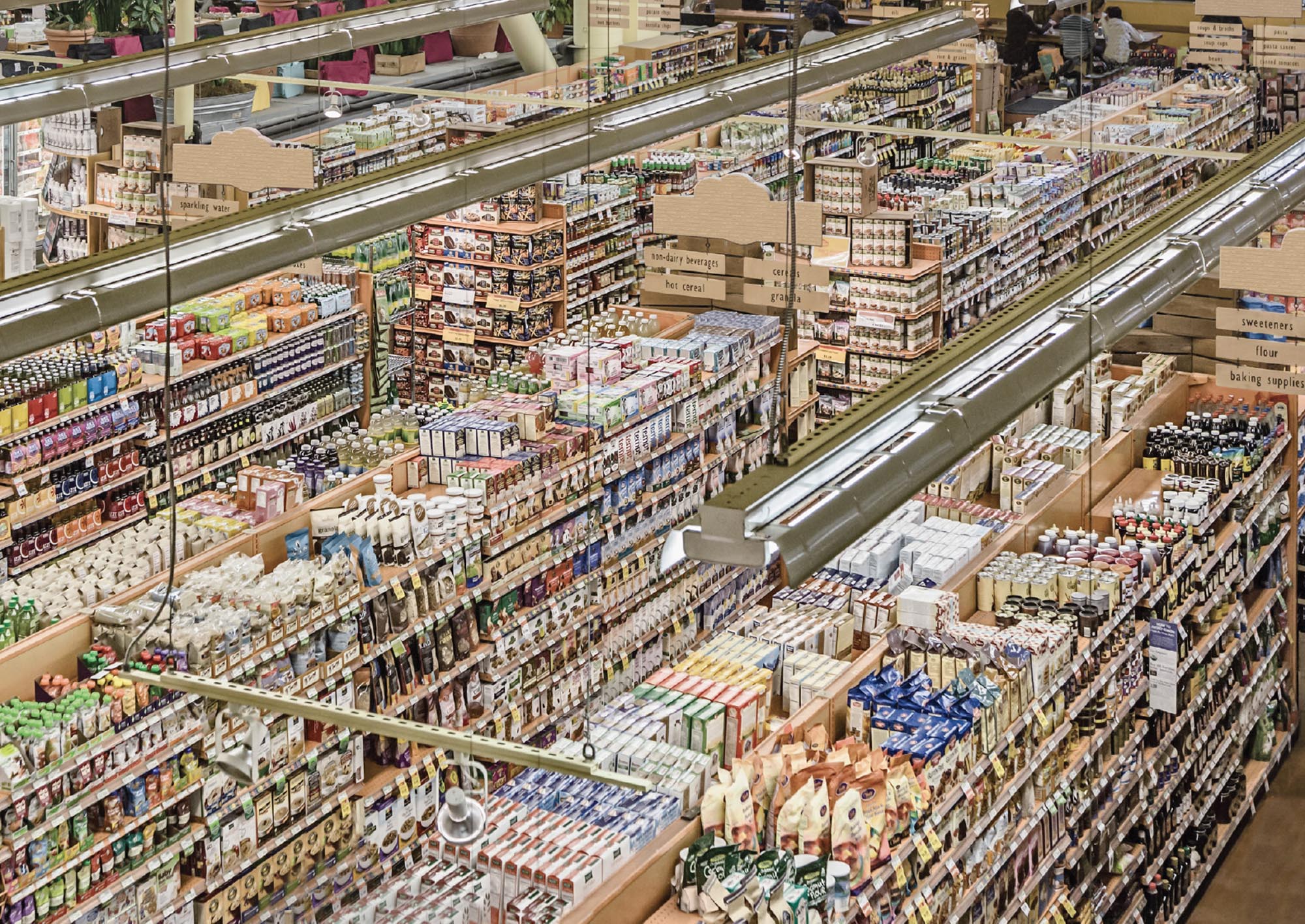 High angle view of a large grocery store aisles packed with food and medicine.