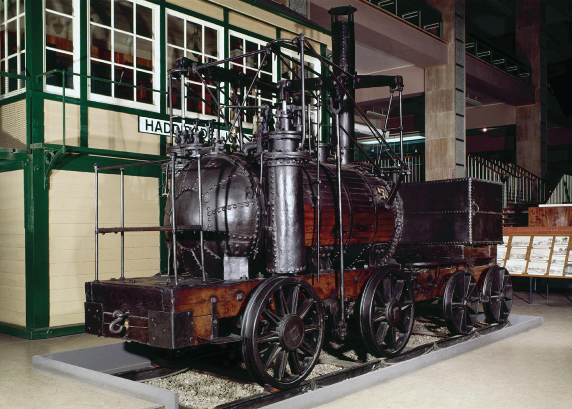 Photograph of one of the first steam-powered locomotives in a museum.