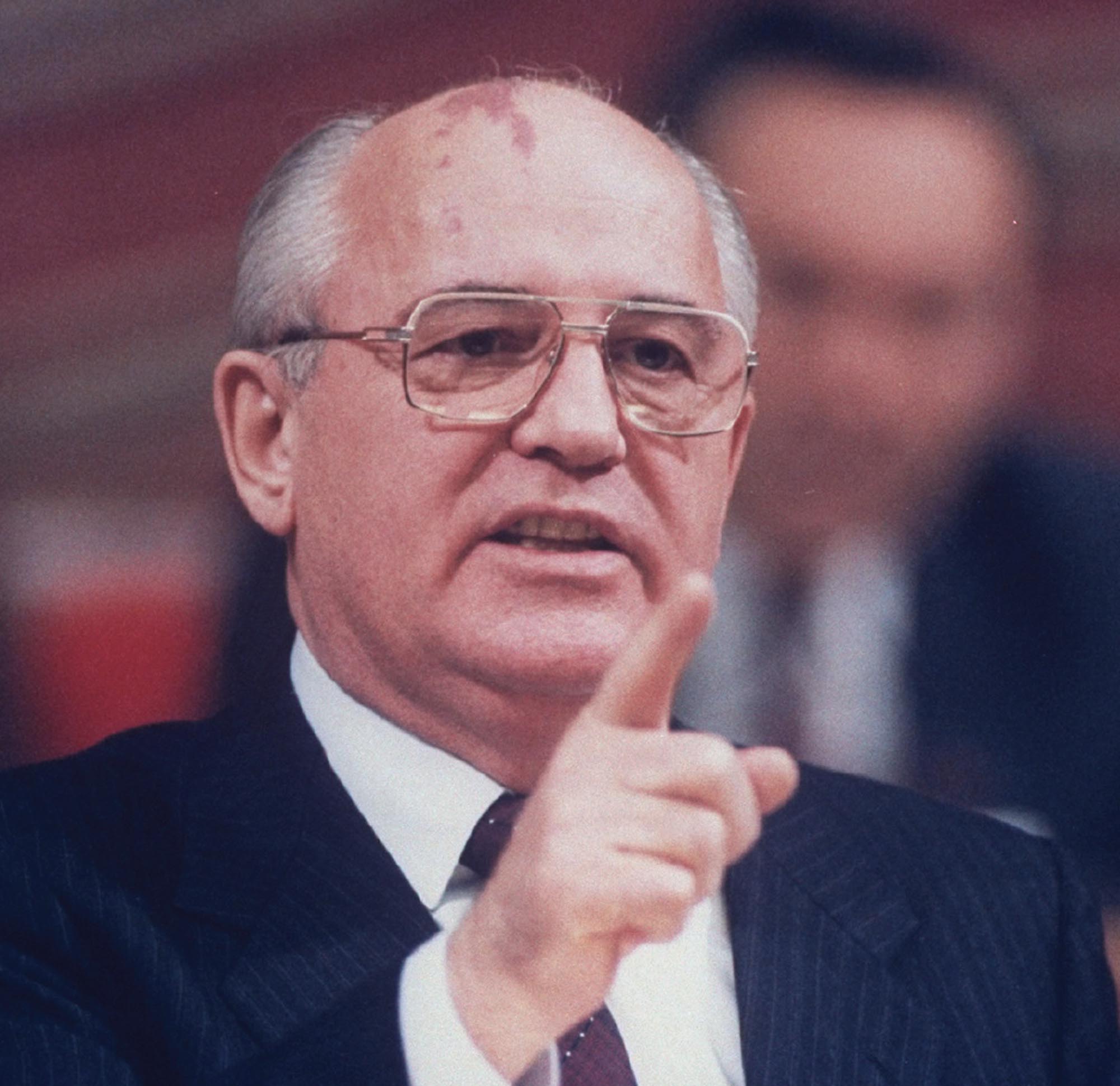 Photo of Soviet leader Mikhail Gorbachev standing behind a podium giving a speech.