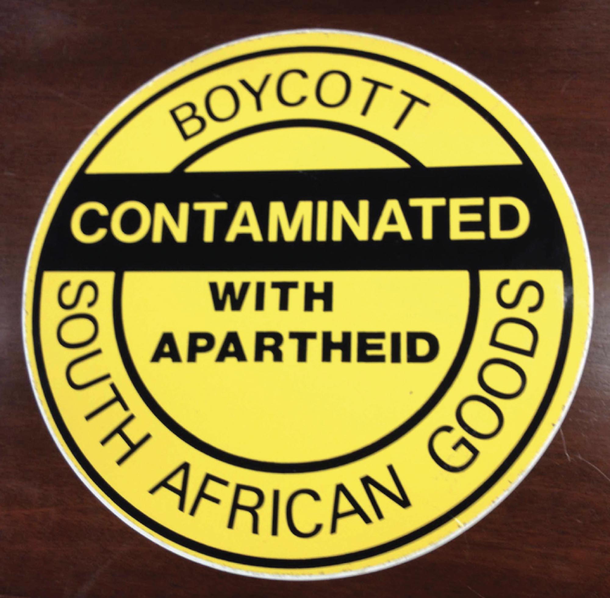 Photo of a yellow sticker advertising a boycott of South African goods due to their contamination with apartheid.