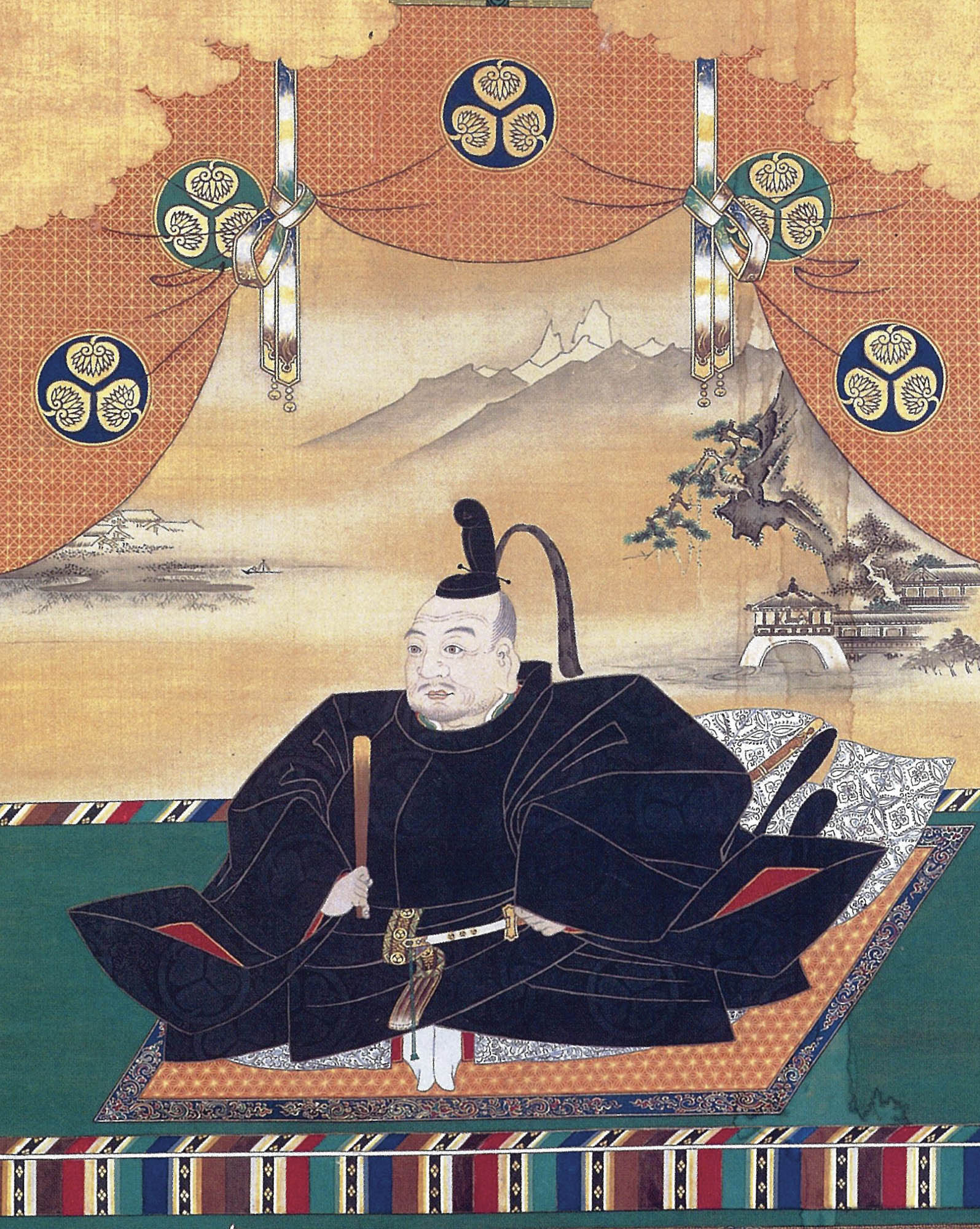 Painting of a Japanese shogun dressed in black robes and sitting cross-legged on an ornate carpet while holding a traditional Japanese paper fan.