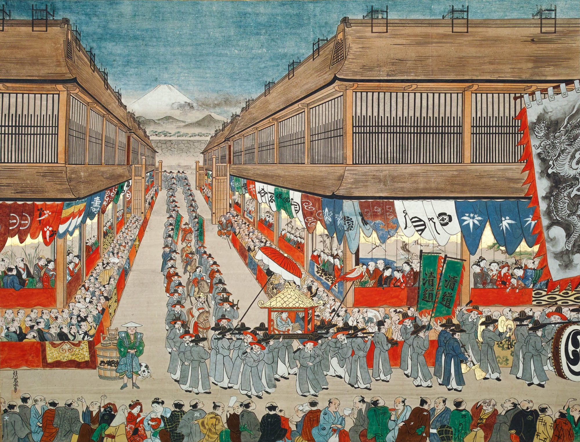 Painting of a diplomatic procession through the streets of a Japanese city. Citizens line the sidewalk as the diplomatic officials walk by in two single-file lines.