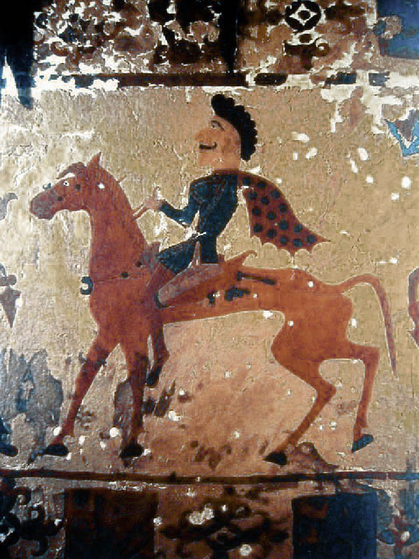 Carpet depicts a man in a dotted scarf on horseback