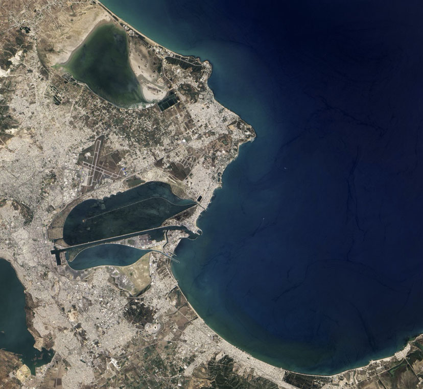 Image of land jutting into a wide expanse of deep blue sea