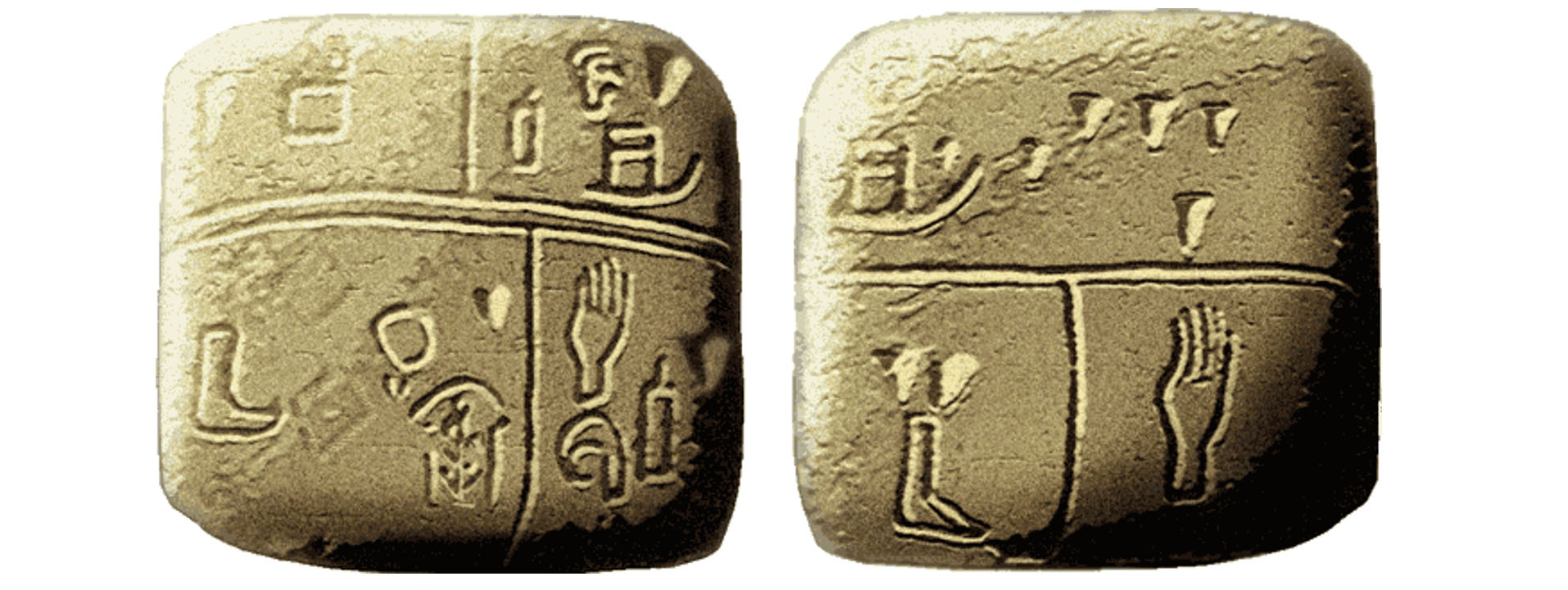 Photo of two square-shaped rocks that have been carved with symbols