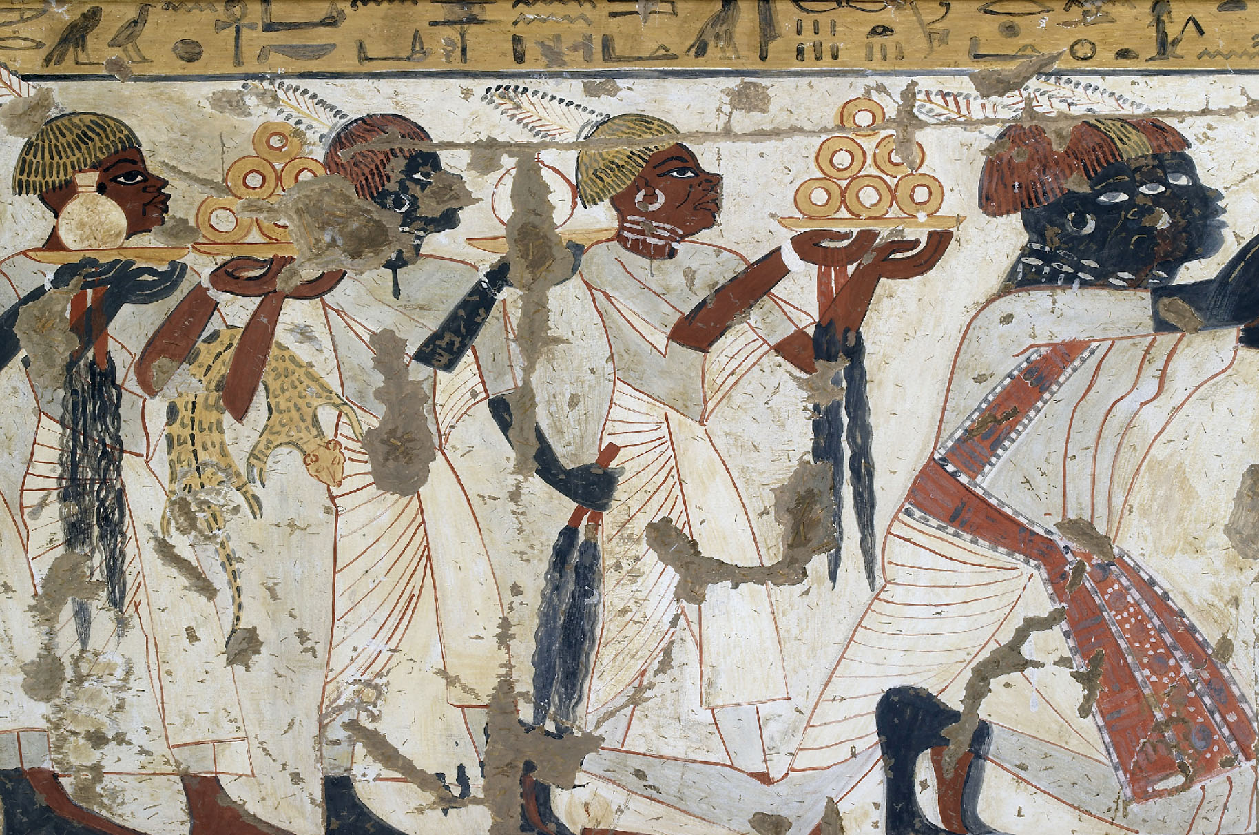 Painting shows several people walking in the same direction, each carrying plates or vessels. One person also carries an animal or animal skin on their arm.