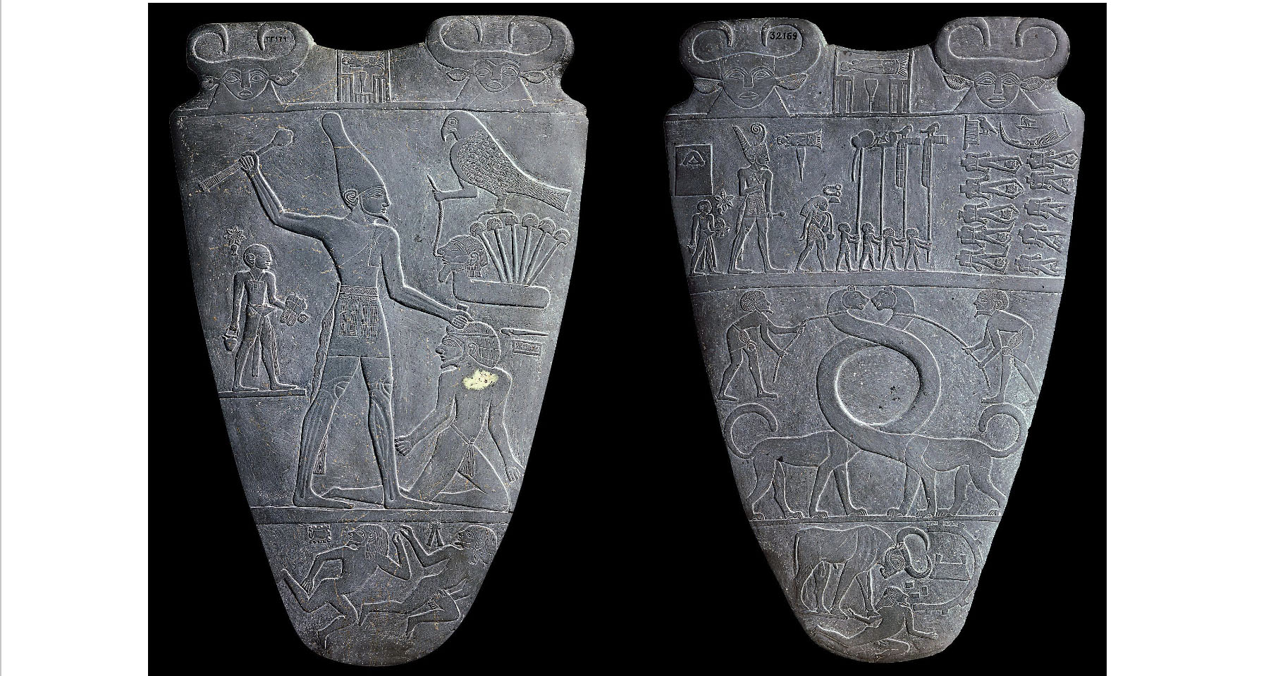 Two stone slabs with detailed scenes carved into them. The scenes appear to depict a battle or siege.