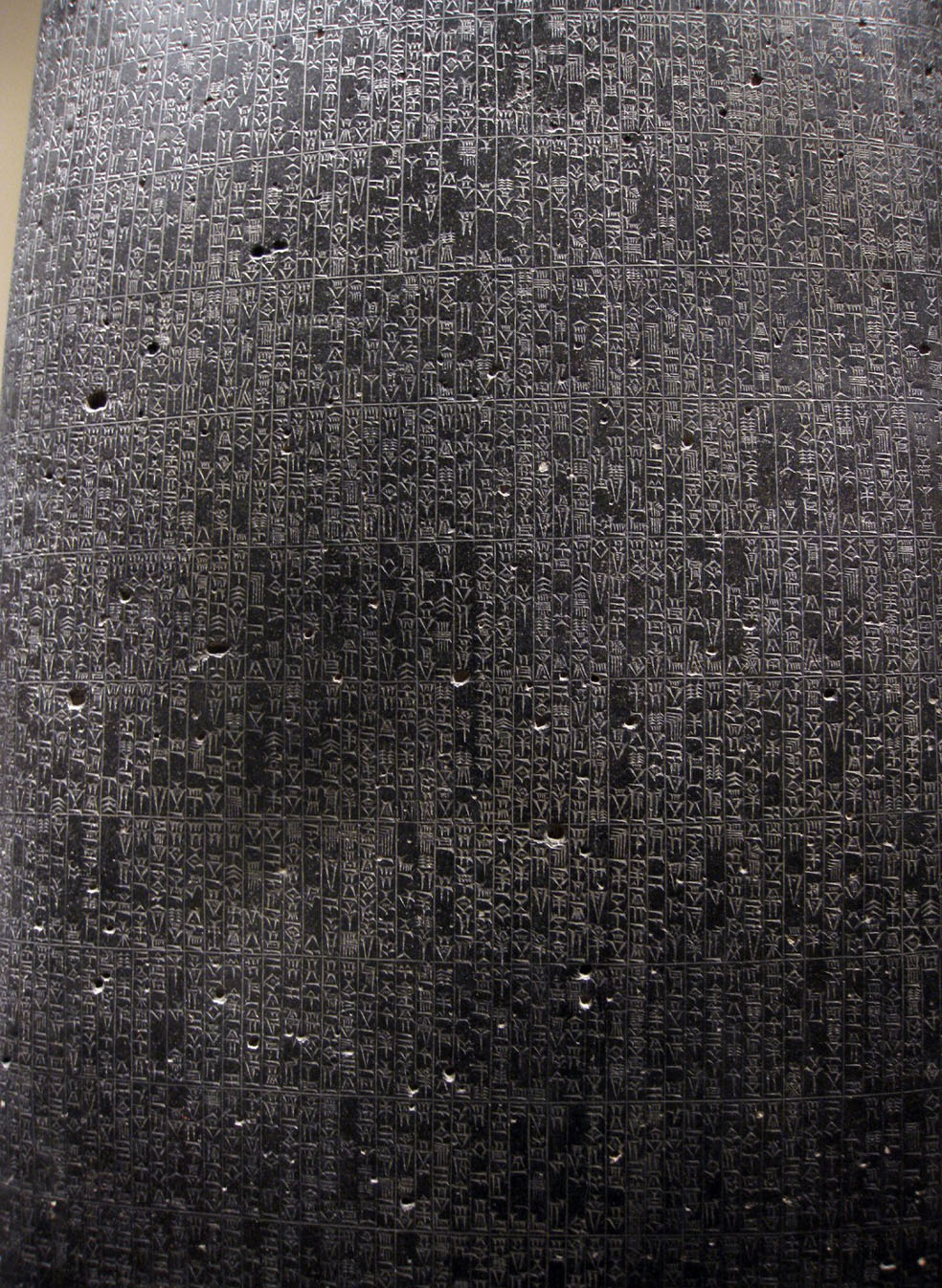 A photo of a wall or panel inscribed with symbols