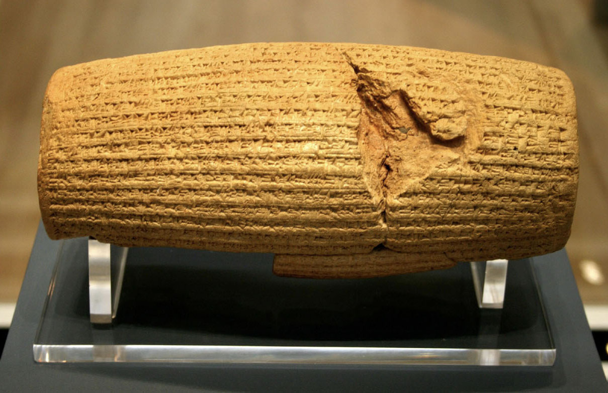 A cylinder-shaped stone carved with script.