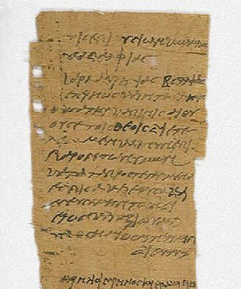 A very old piece of paper or papyrus with script written on it.