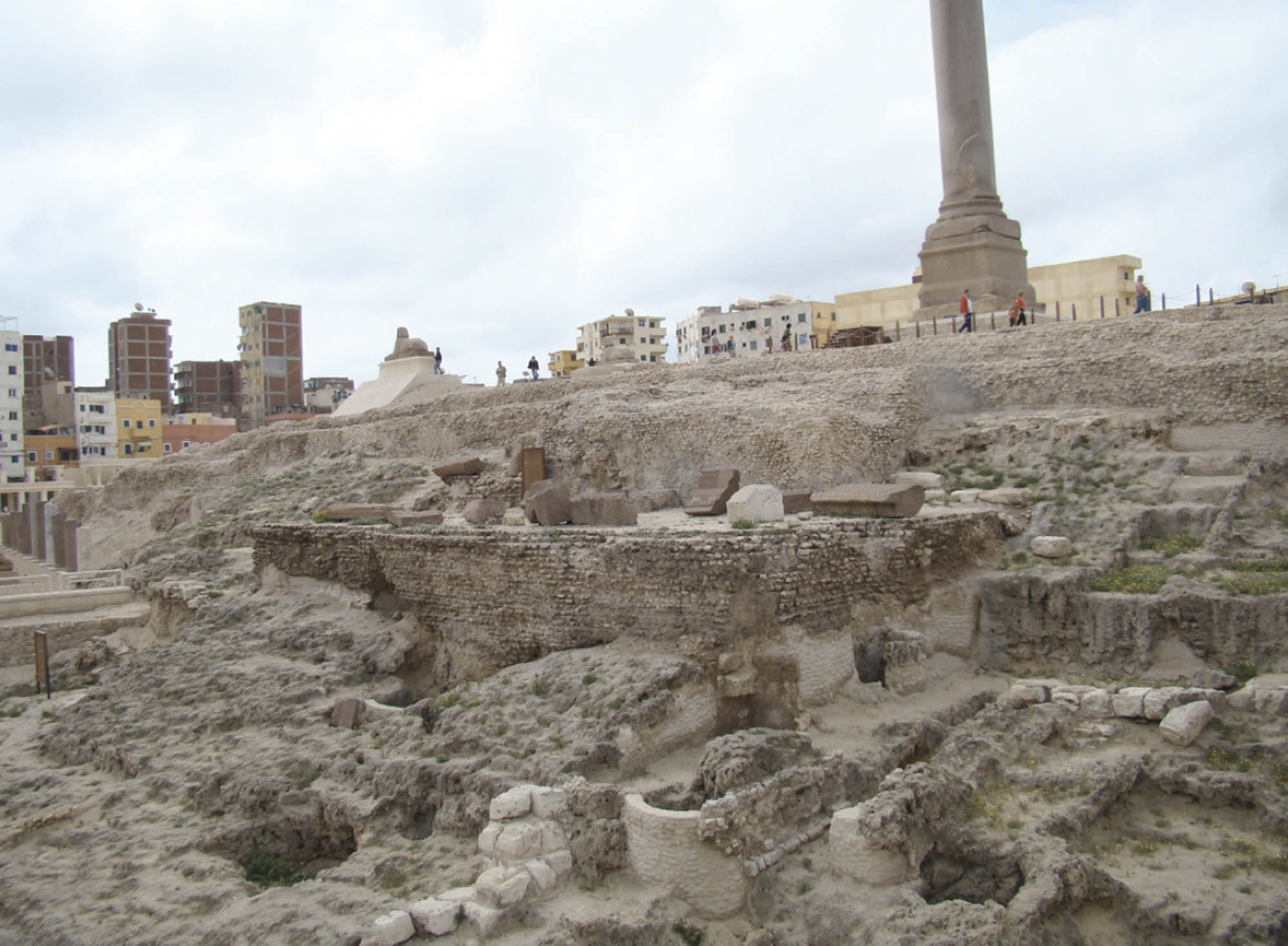 What is left of a temple: mostly fallen down rock, but some remnants of stone walls remain.