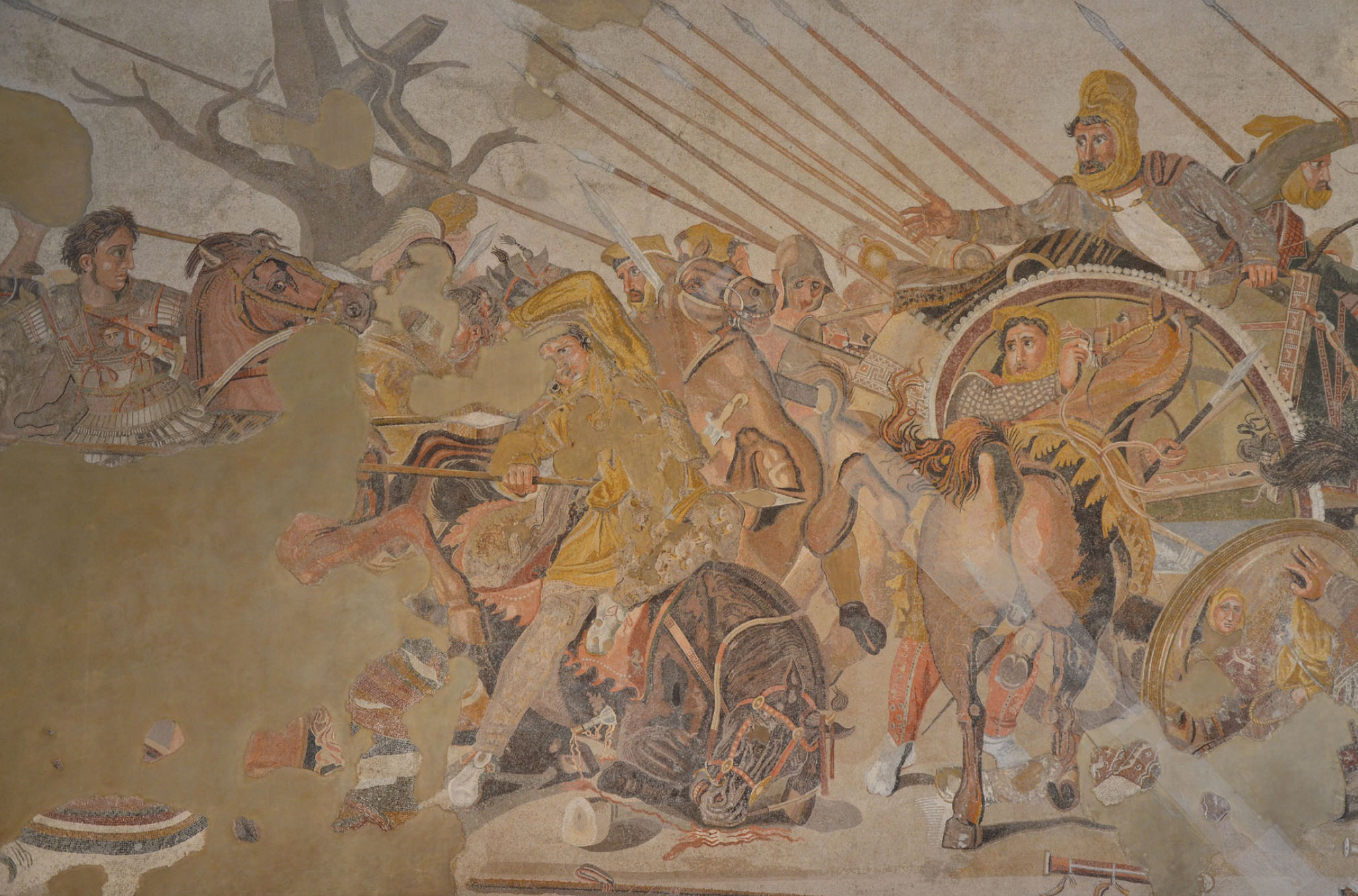 Incredibly detailed (but partially destroyed from age) mosaic featuring a battle scene. Men are on horseback, pointing spears.
