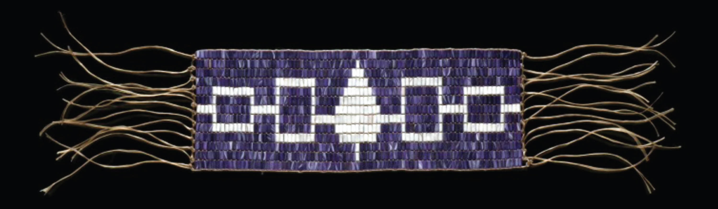 A photograph showing the symbols used to represent the 5 tribes of the Iroquois Confederacy on a woven belt. From left to right: The Seneca (white outlined square), The Cayuga (white outlined square), The Onandaga (white arrow shape), The Oneida (white outlined square), The Mohawk (white outlined square). The symbols are connected by white horizontal lines.
