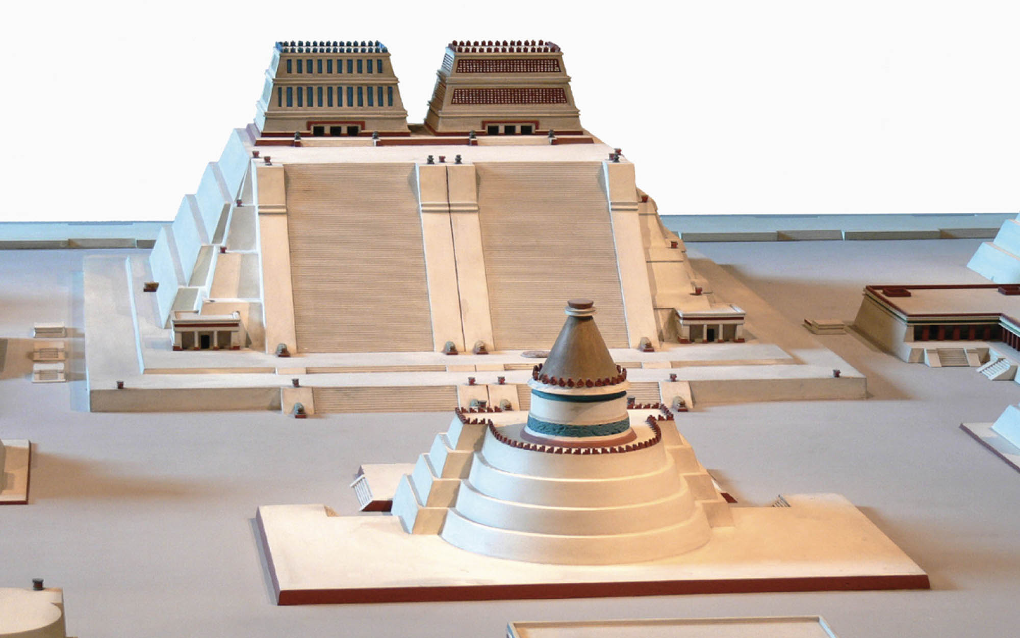 A model shows impressive structures facing one another. The structures are flat-topped pyramid shapes. On top of the pyramids are great structures or buildings.