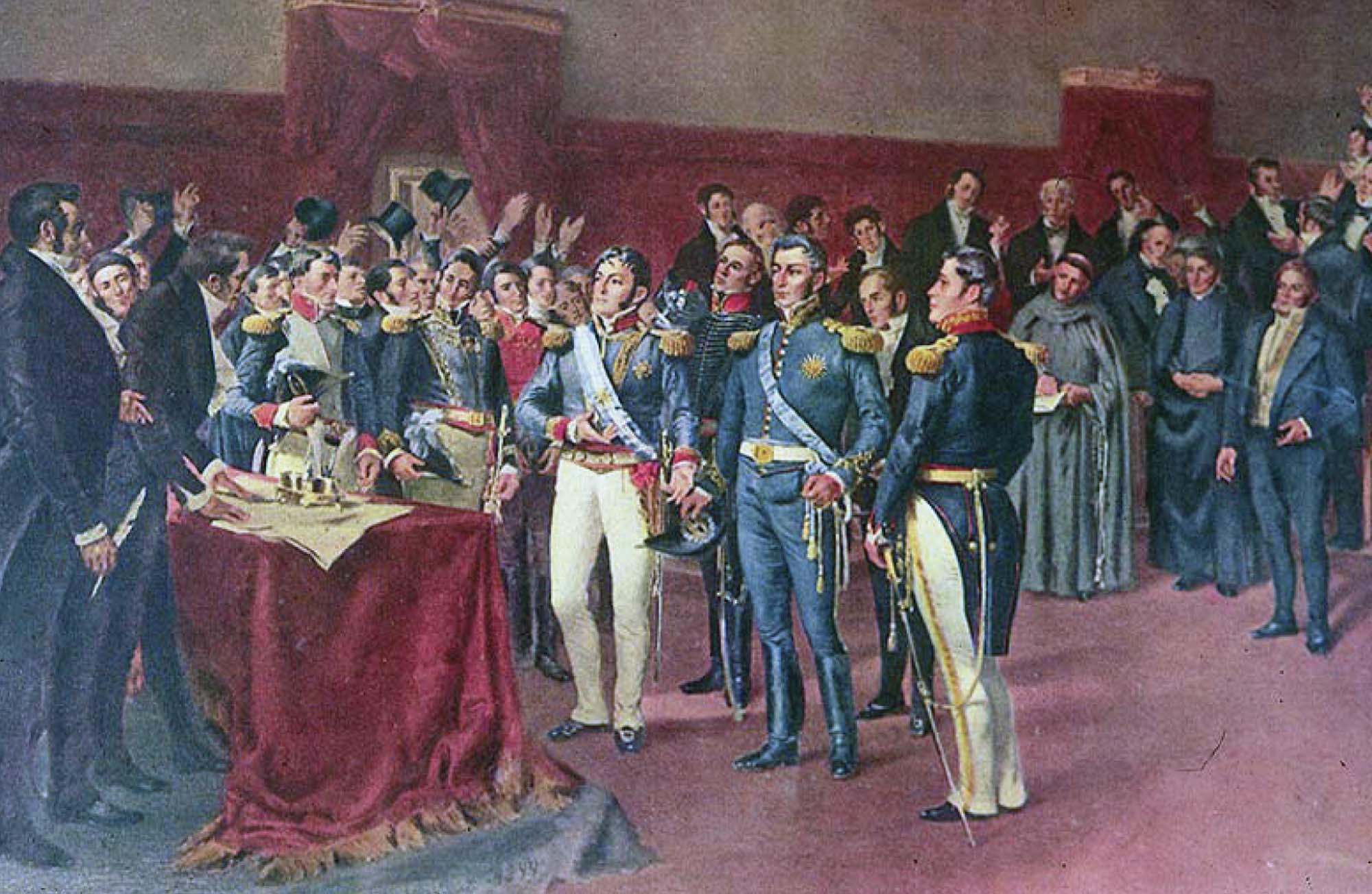 Several men in uniform clap as another is presented with an award.