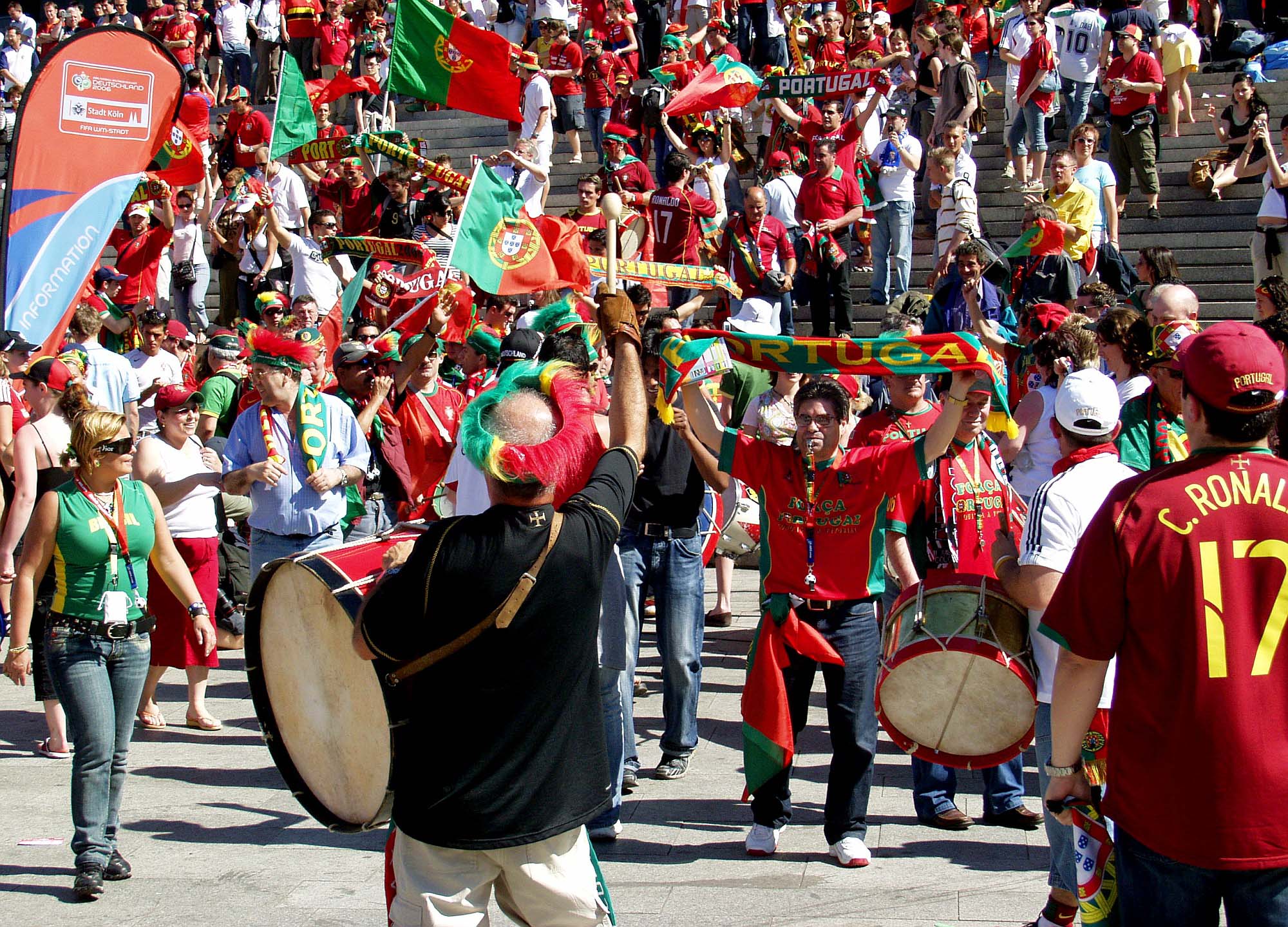Photo of a crowd of Portuguese national soccer team fans. Most of the fans are wearing red and green, the same colors as the nation’s flag.