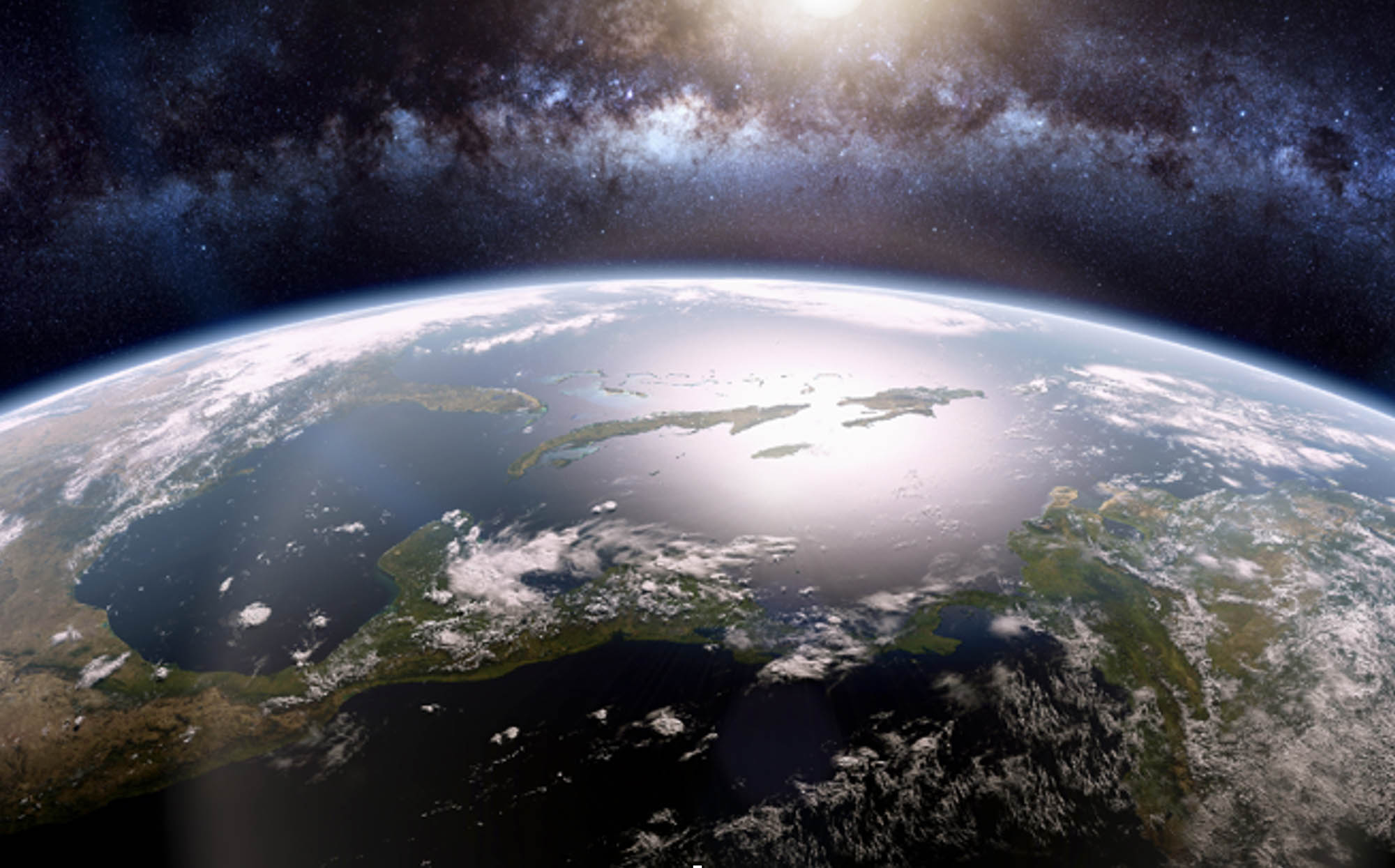 Sunrise over the Earth with Milky Way in the background.