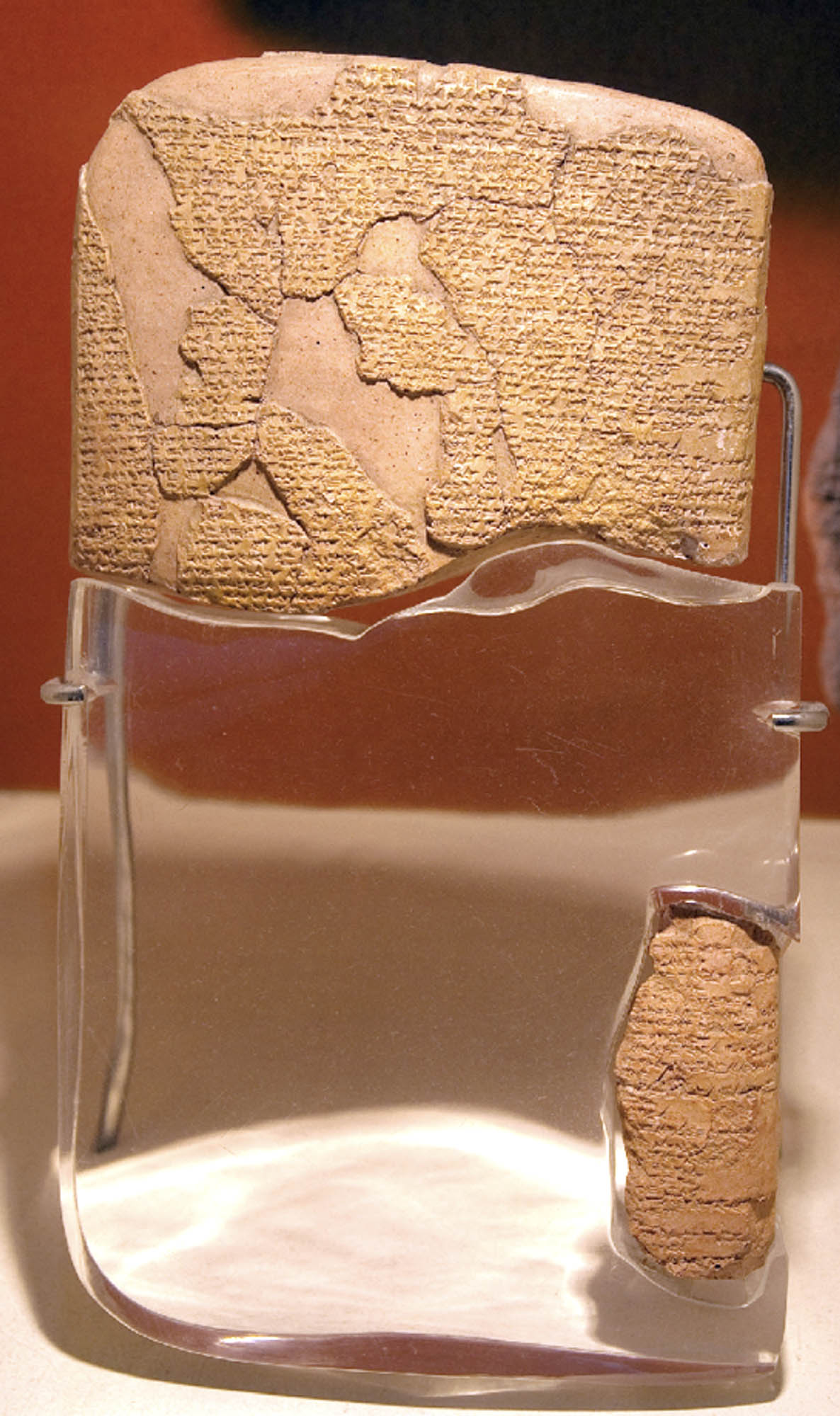 Pieces of a broken tablet with ancient writing.