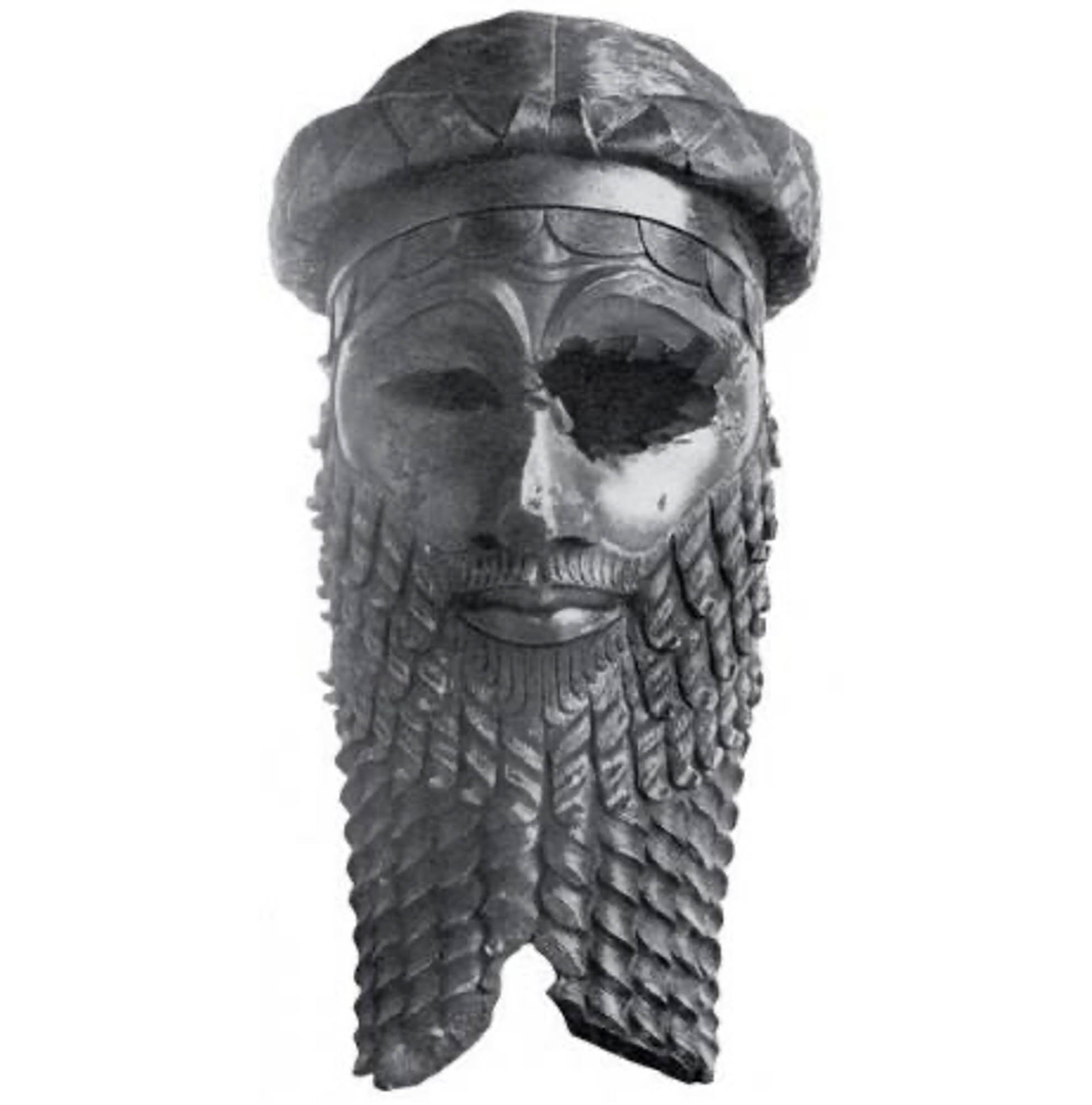 Bronze sculpted head of an Akkadian emperor featuring a very detailed carved beard and hat. One eye is missing from the sculpture, probably a result of age decay.