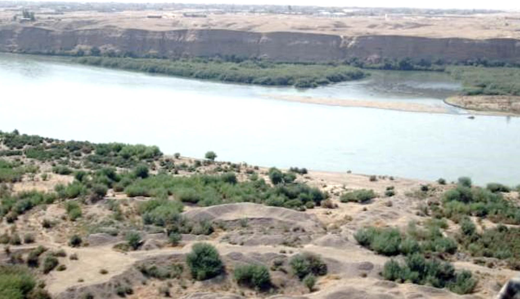 A photo of the Tigris River and surrounding land.