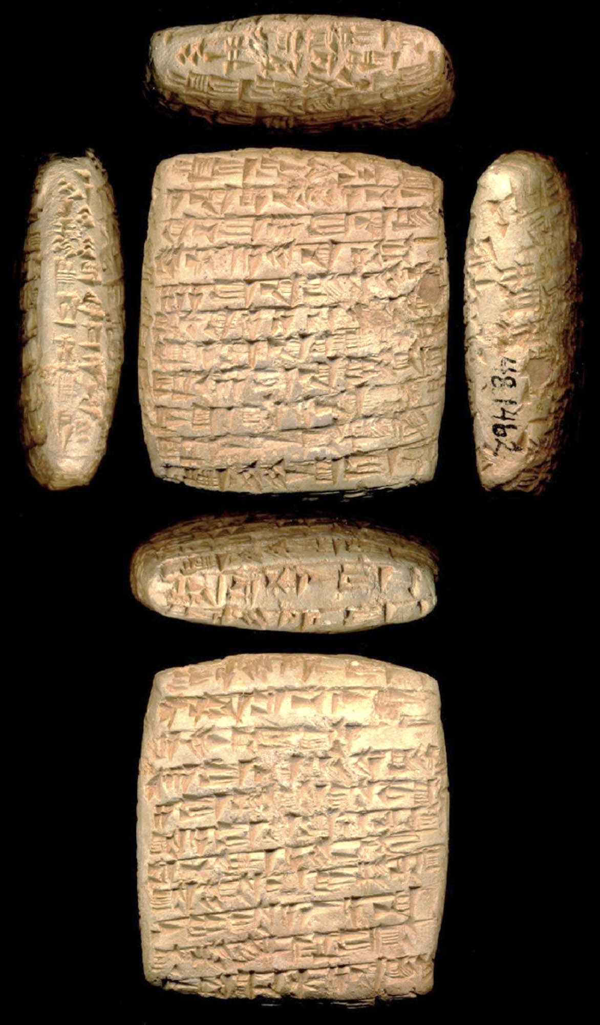 A six-sided clay tablet with inscribed with script.