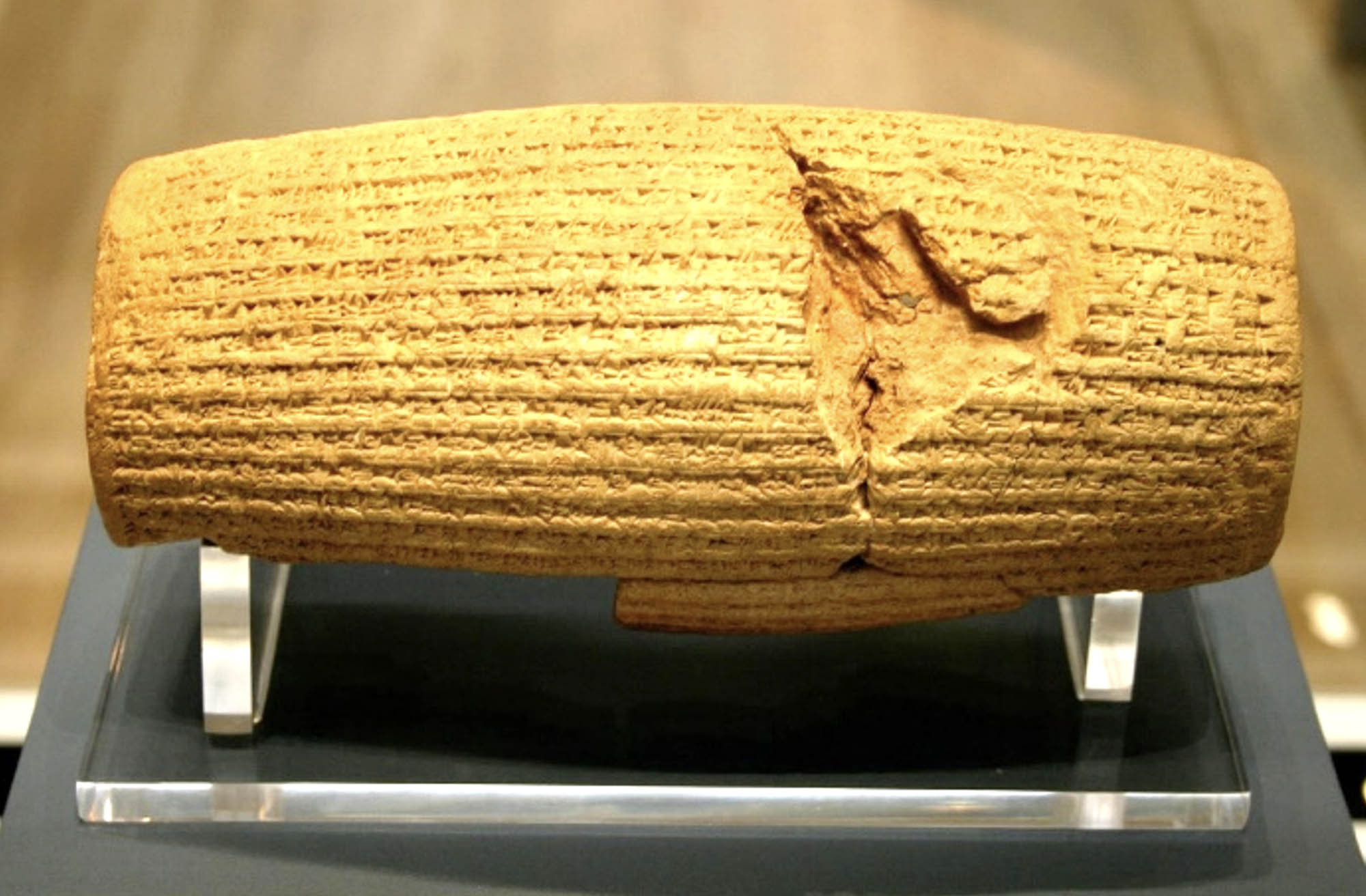 A cylinder-shaped stone carved with script.