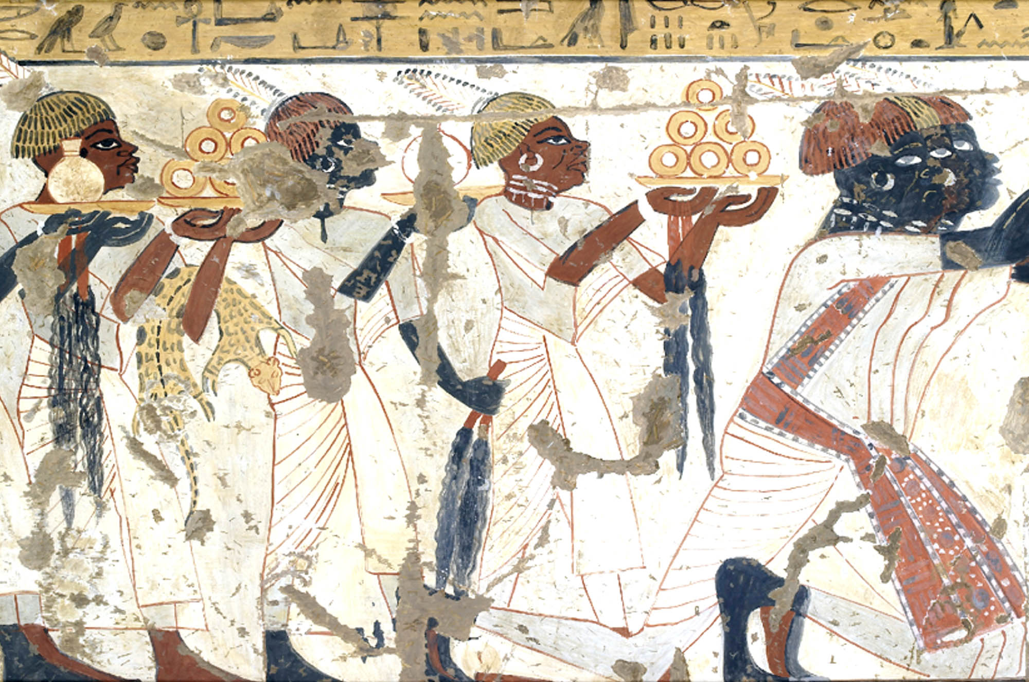 Painting shows several people walking in the same direction, each carrying plates or vessels. One person also carries an animal or animal skin on their arm.