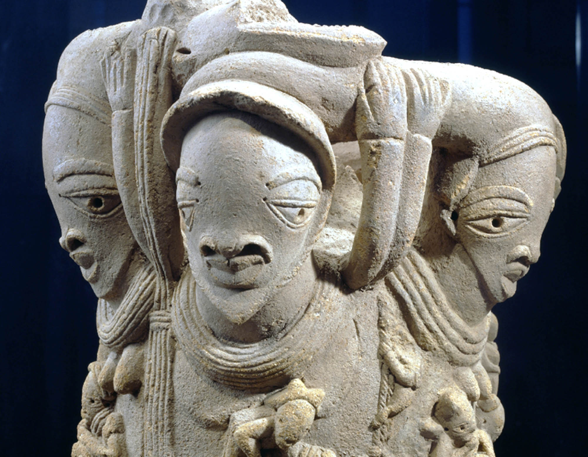 Photograph of a three-headed stone statue