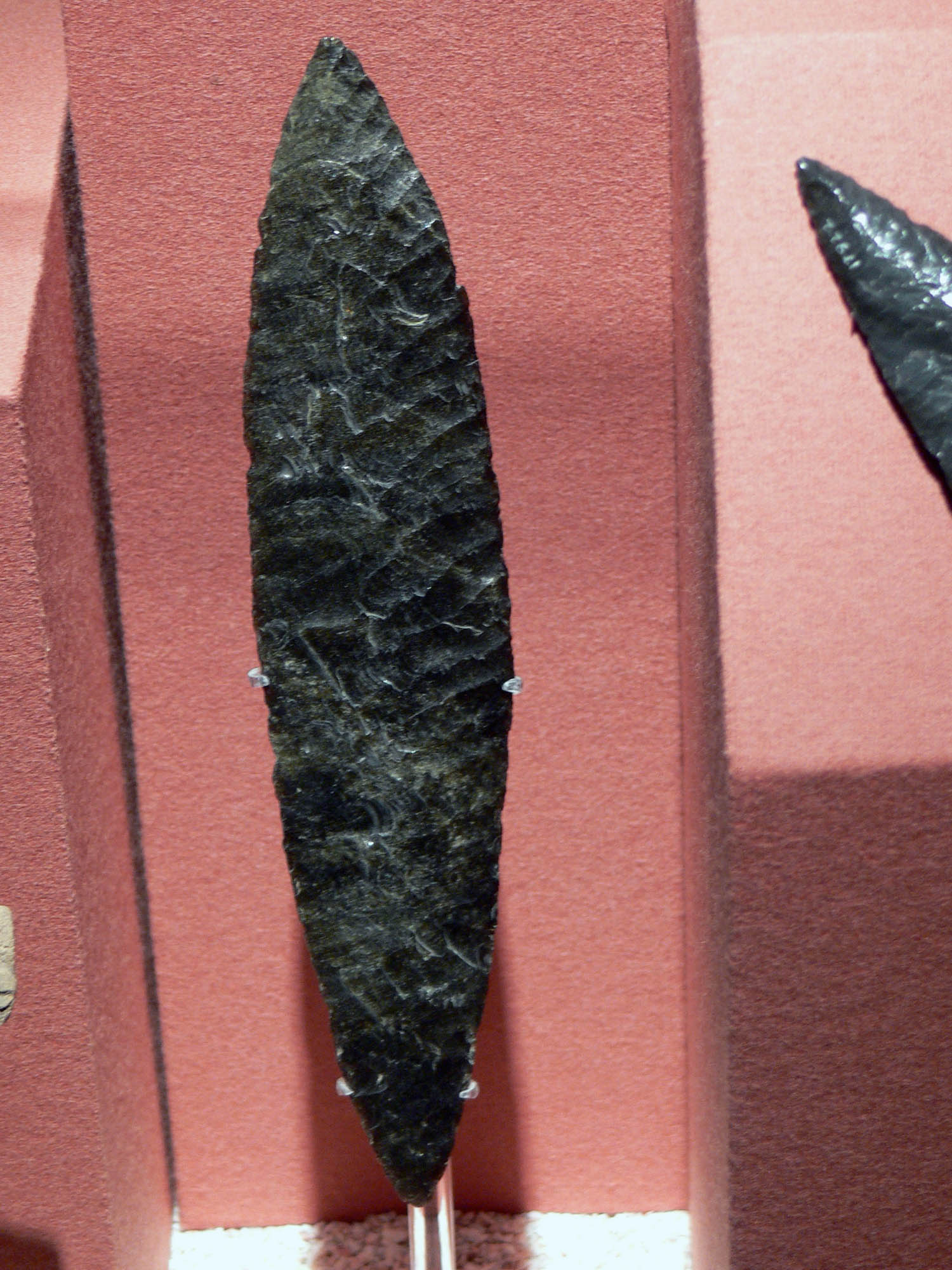 A sharpened, blackened tool carved from obsidian.