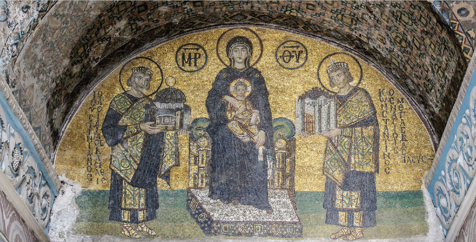 A detailed mosaic depicts a woman, holding a baby, with a man at either side. Each man is holding a castle, perhaps representing their empires.