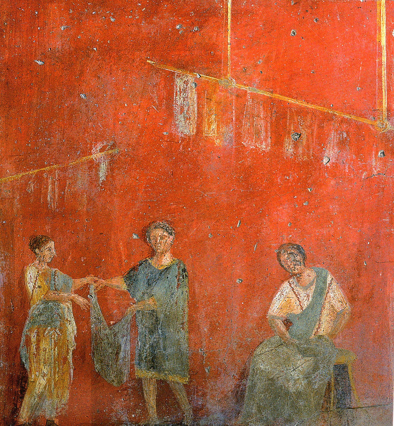 Detail of a Roman fresco in Pompeii. Three workers in a laundry, one washes while two others hang clothes for drying.